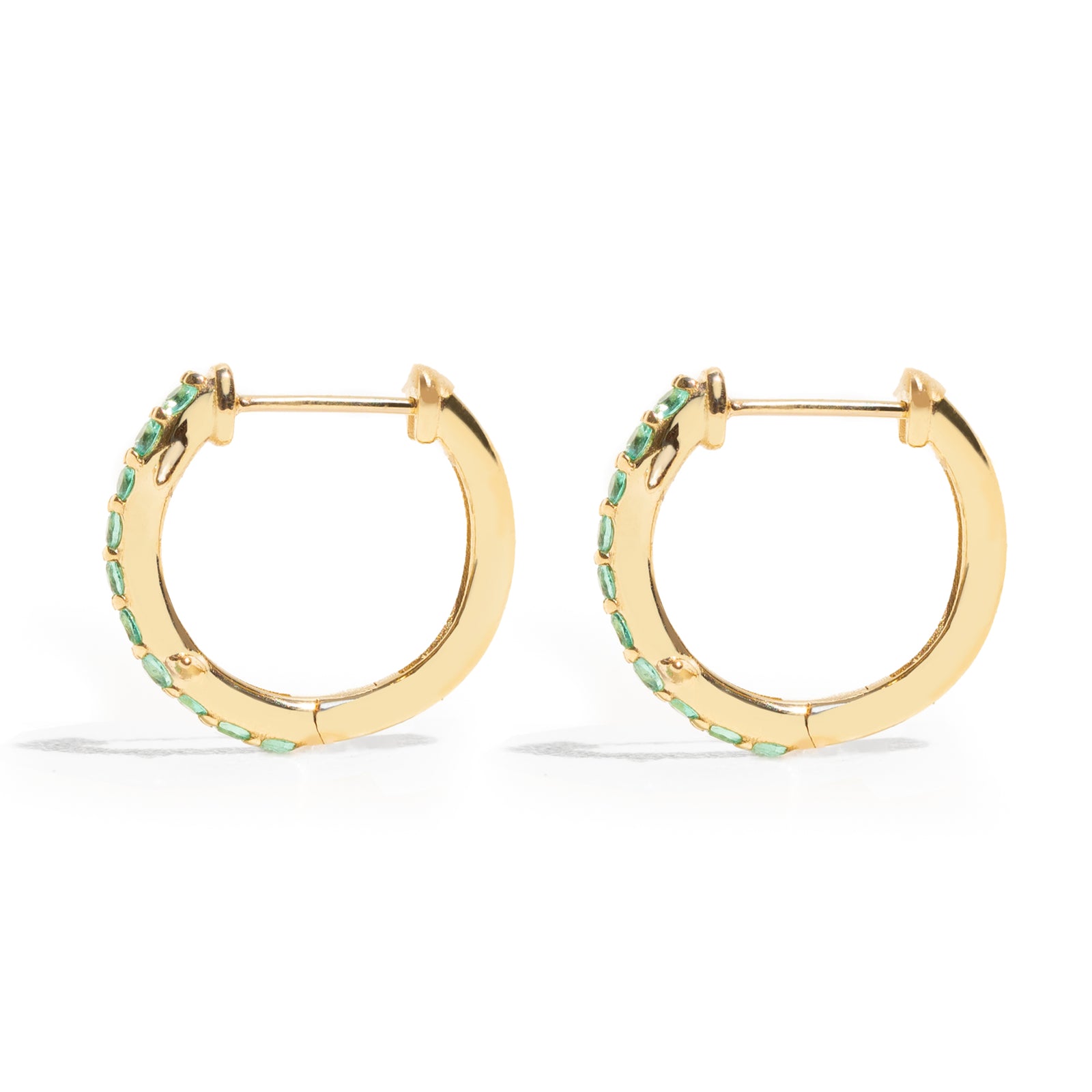 Thorn_Hoops_Emerald_Bold yet refined, the Thorn Emerald Hoop features a delicate thorn silhouette accented with vibrant emeralds. Edgy and elegant, it’s designed for those who love a touch of drama in an understated form.