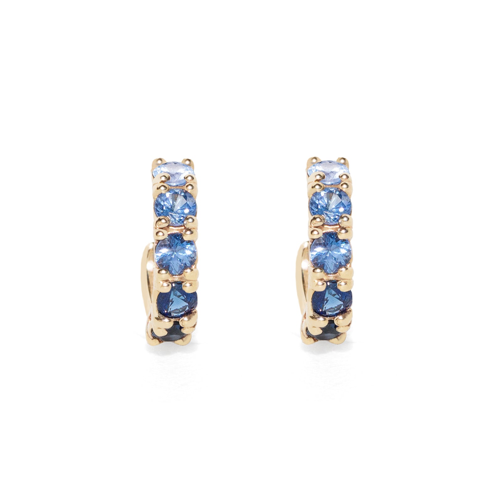 Gold hoop earrings with blue sapphire on a white background