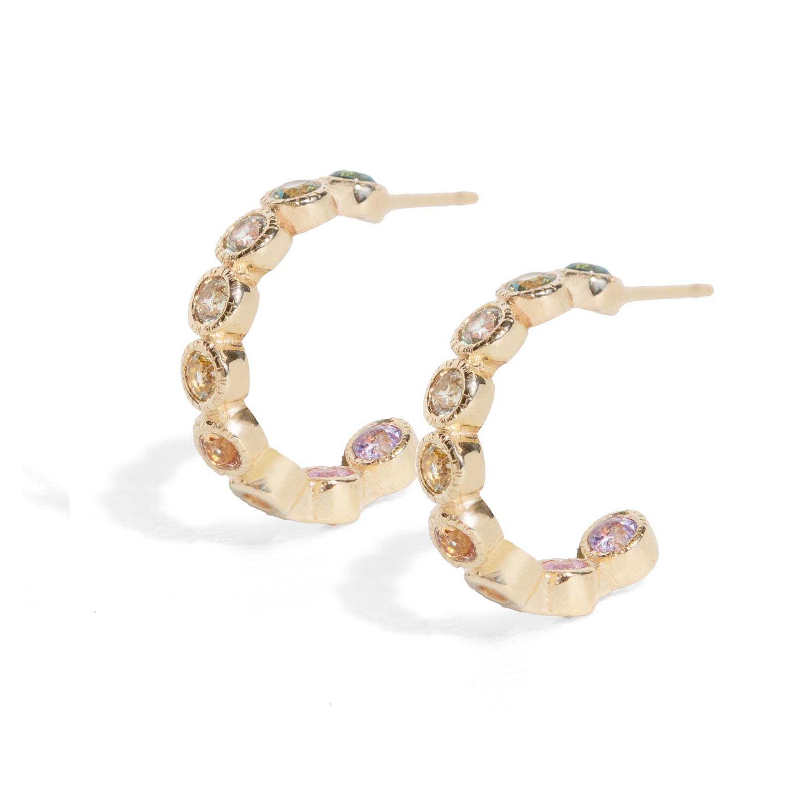 Gold hoop earrings with embedded gemstones on a white background