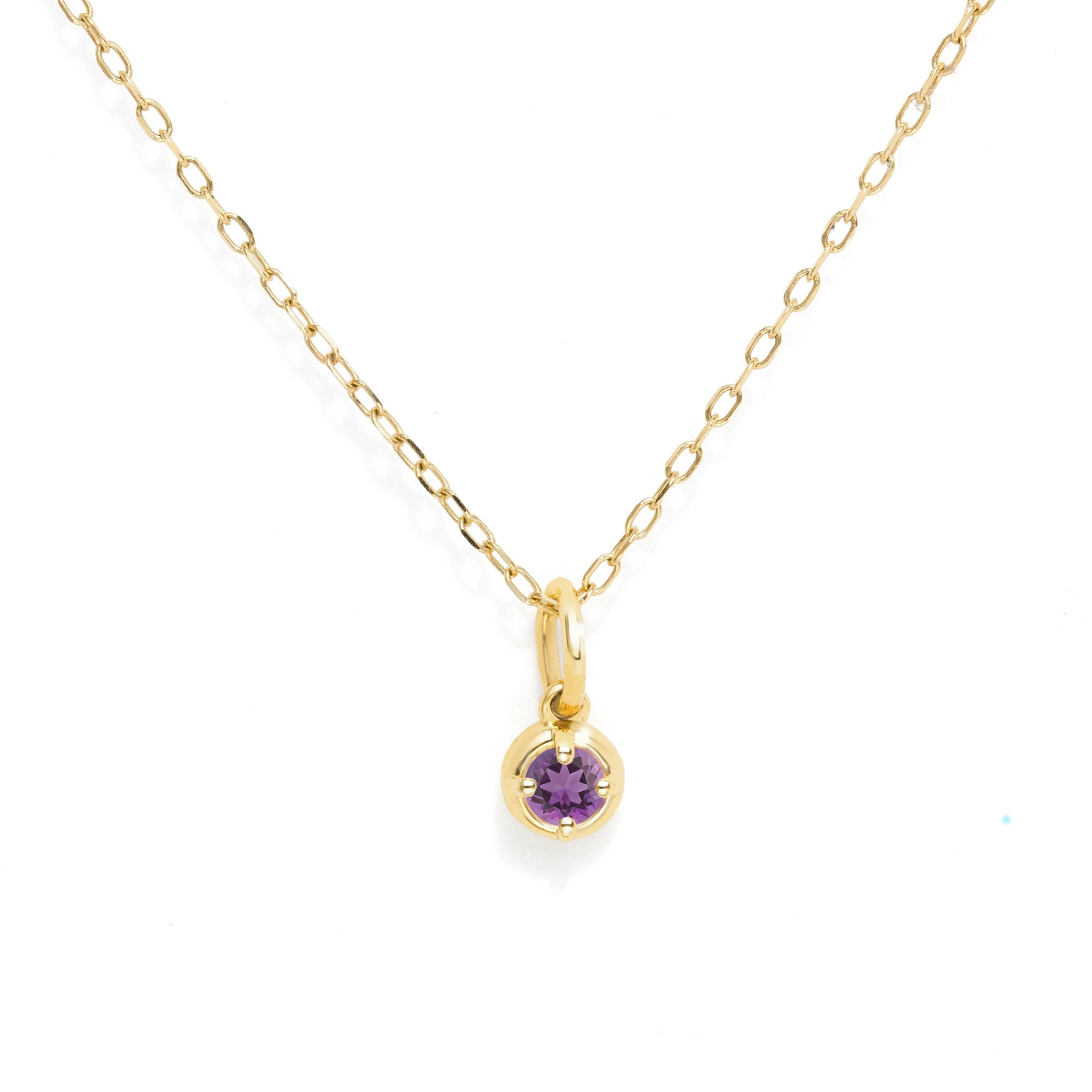 A delicate yellow gold chain necklace with a small round purple amethyst pendant, displayed on a clean white background.