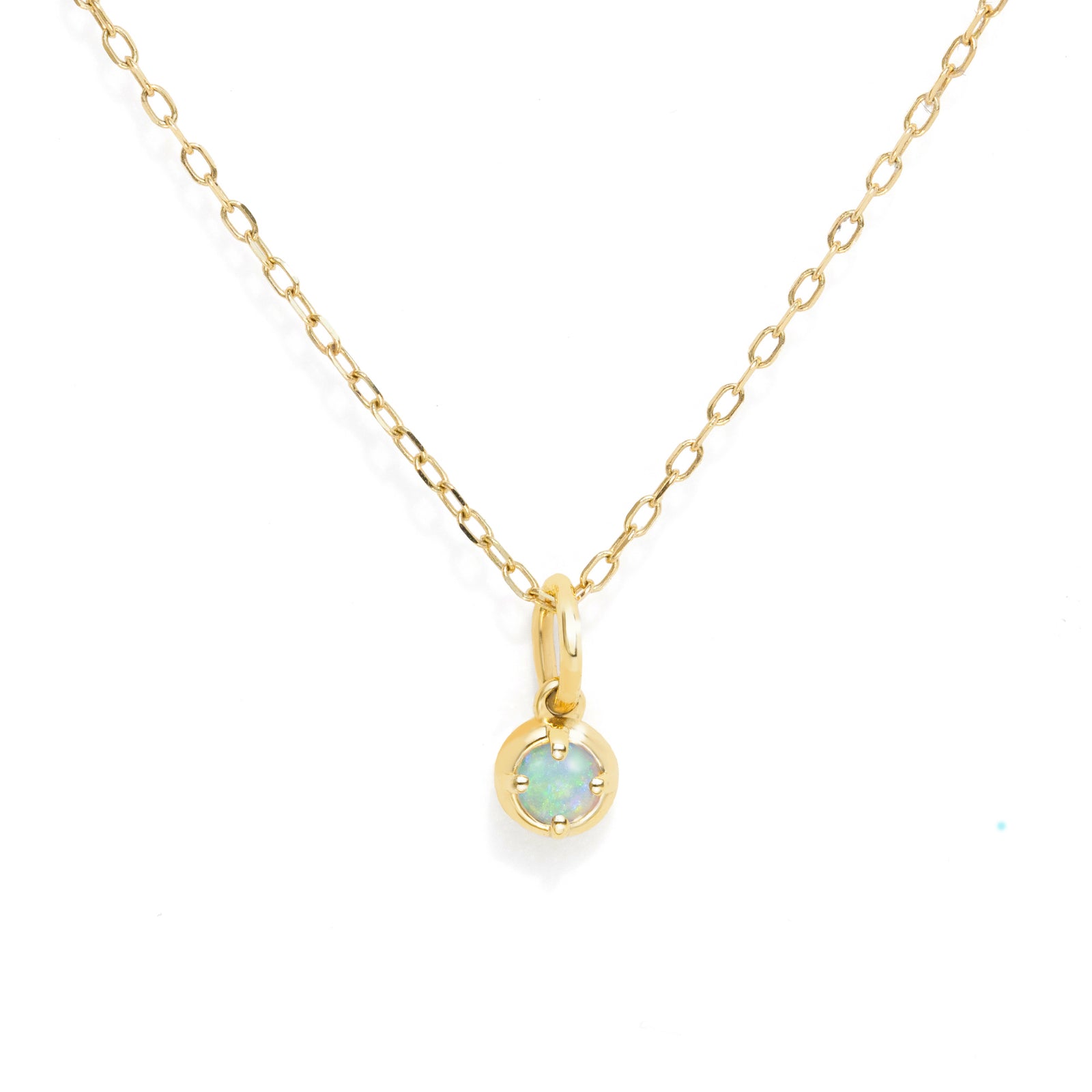 A delicate gold chain necklace with a small round-set opal pendant on a white background.