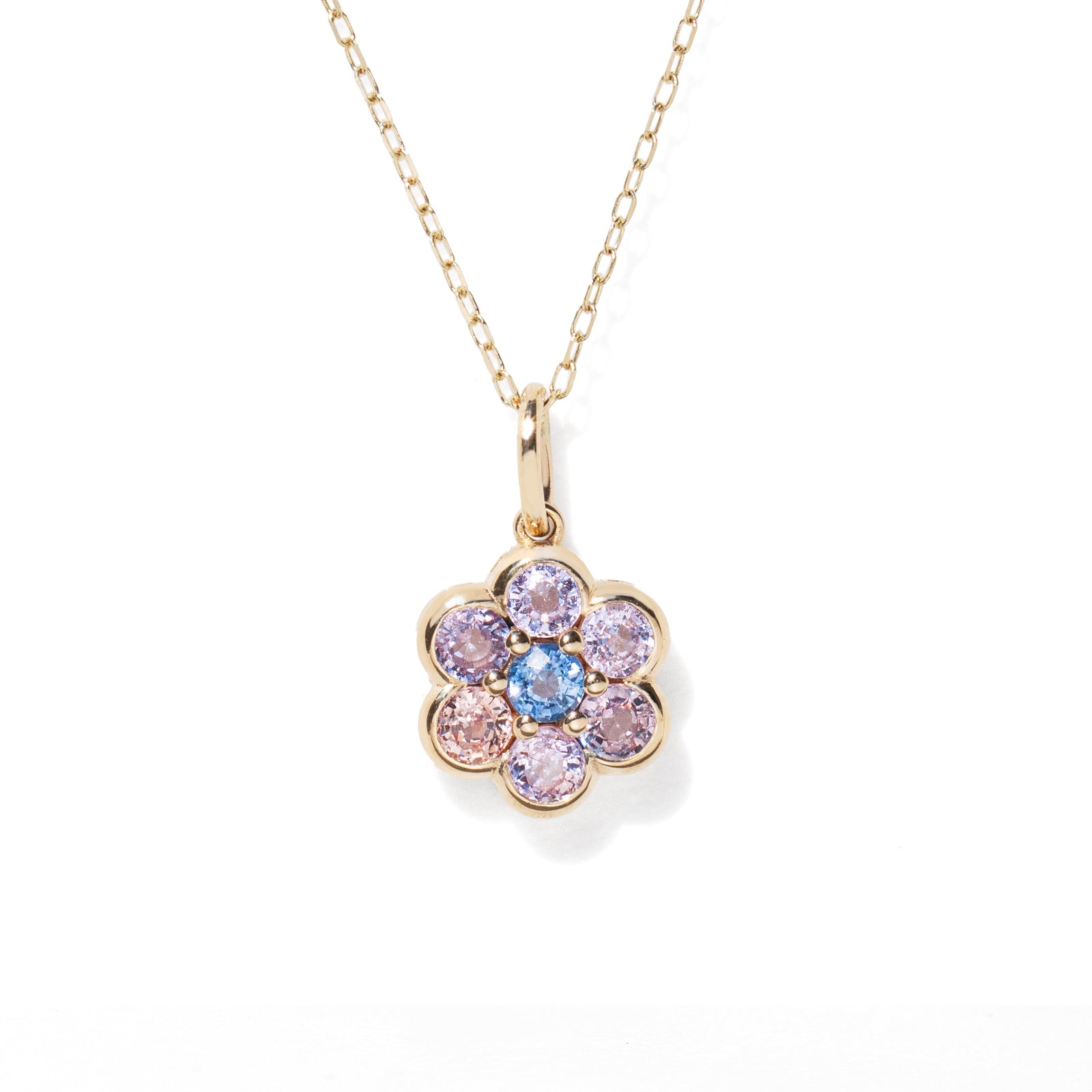 Gold necklace with a colorful flower-shaped pendant on a white background