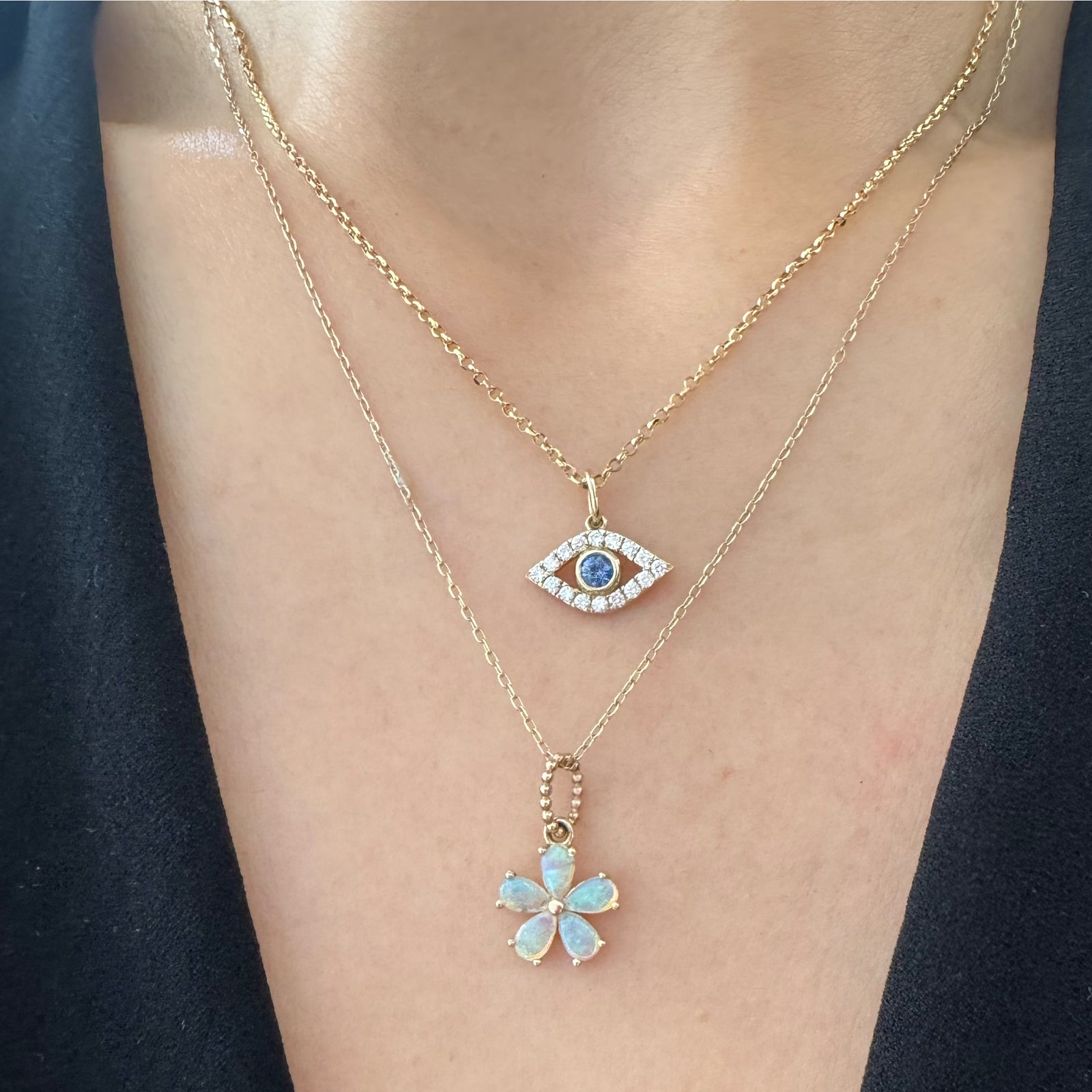 two gold color gemstone necklaces on a neck.
