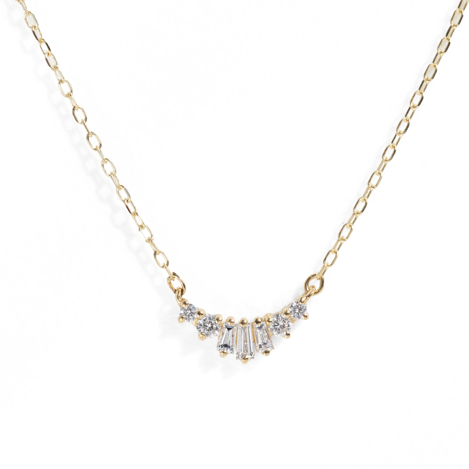 Gold necklace with diamond pendant on a white background