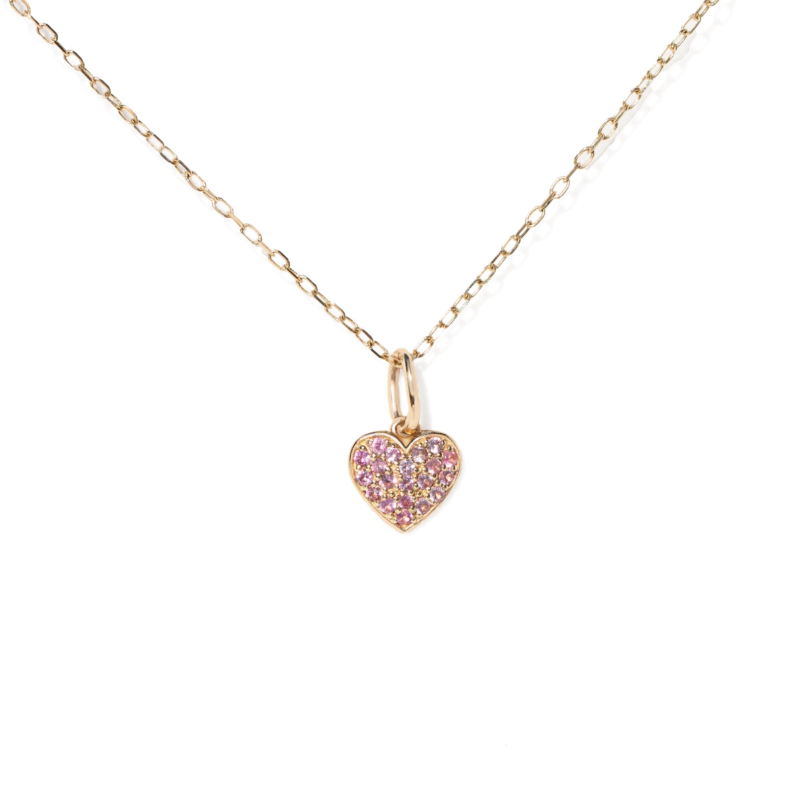 Gold necklace with a pink heart-shaped pendant on a white background