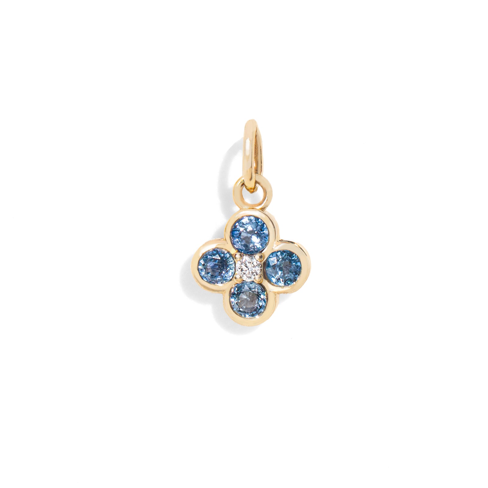 Gold pendant with blue gemstones on a white background