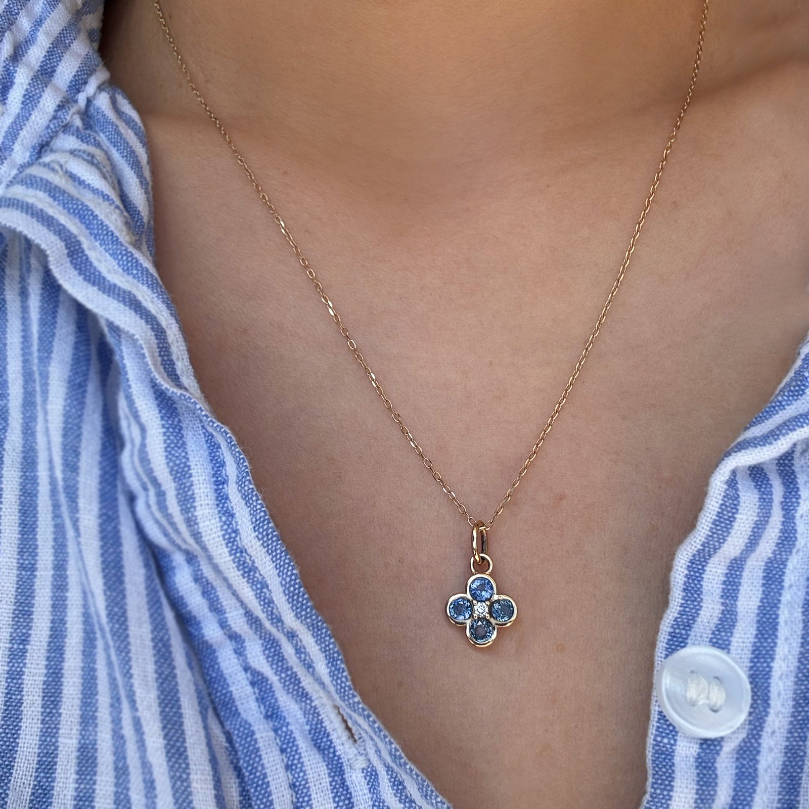 A gemstone necklace worn on a woman's neck.