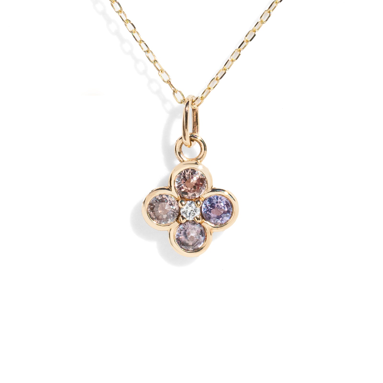 Gold necklace with a four-leaf clover pendant featuring multicolored gemstones on a white background.