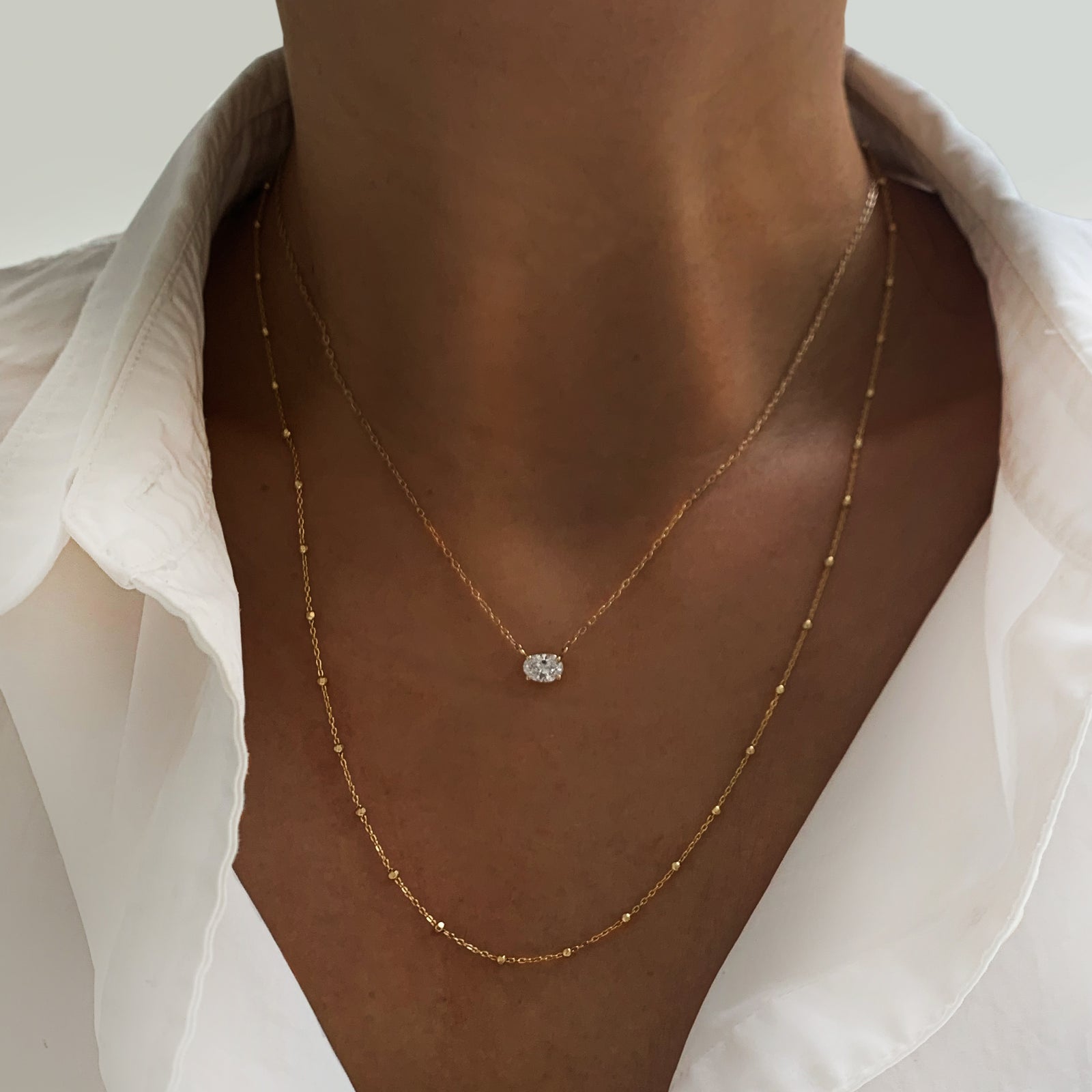 Jamie Park Oval Diamond Solitaire Necklace This Oval Diamond Solitaire Necklace features a sparkling lab diamond, set in a classic four prong design. With each diamond certified by IGI, this necklace makes for a timeless and cherished gift, perfect for any special occasion. Add a touch of elegance to any outfit with this beautiful piece. Chain length 16-18" 