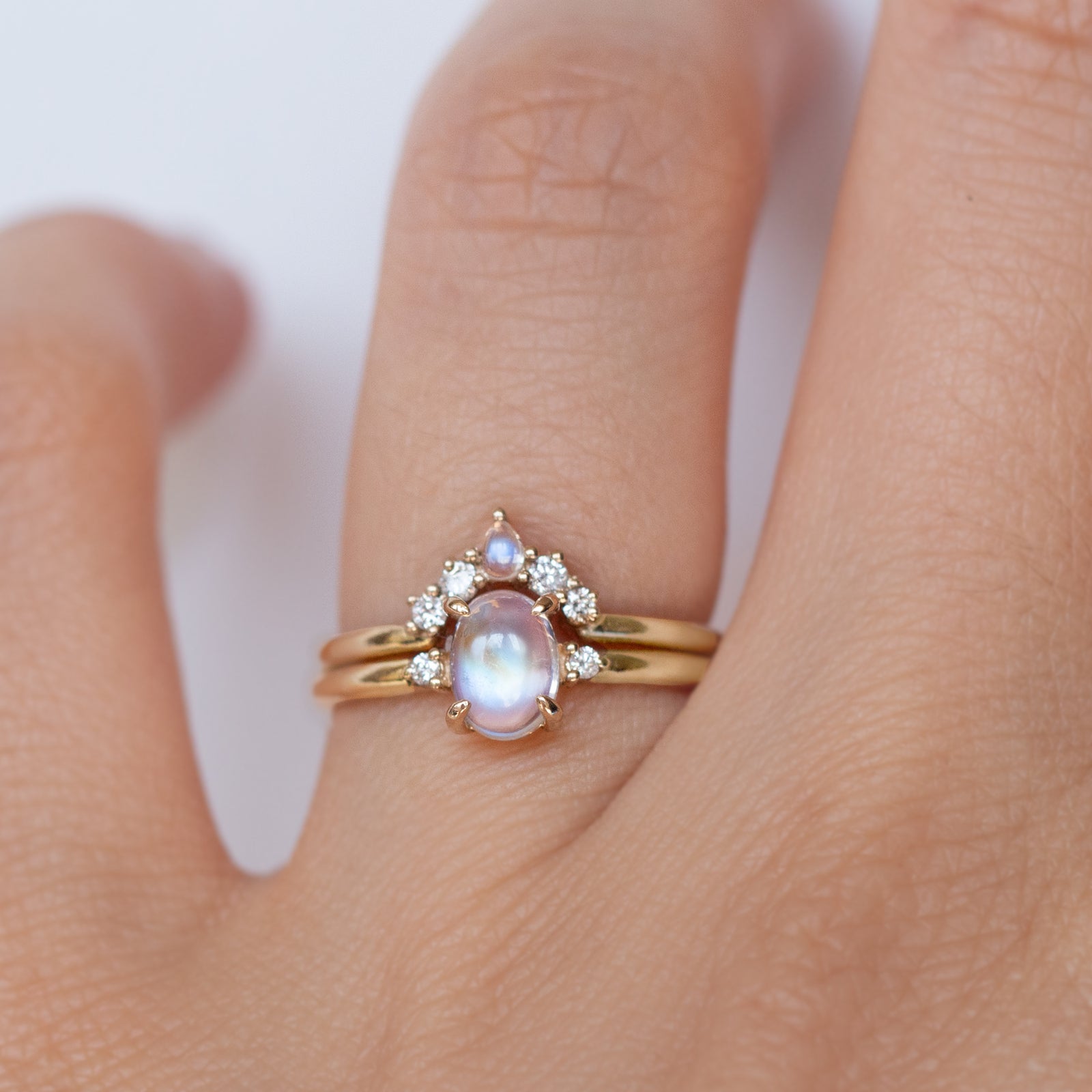 The classic Grace Ring's three stone design makes it perfect for your special day. This unique ring features an oval rainbow moonstone adorned with small diamonds, making it a truly one-of-a-kind piece. Pair this ring with Blossom Moonstone Contour Band to create your dream ring stack. 