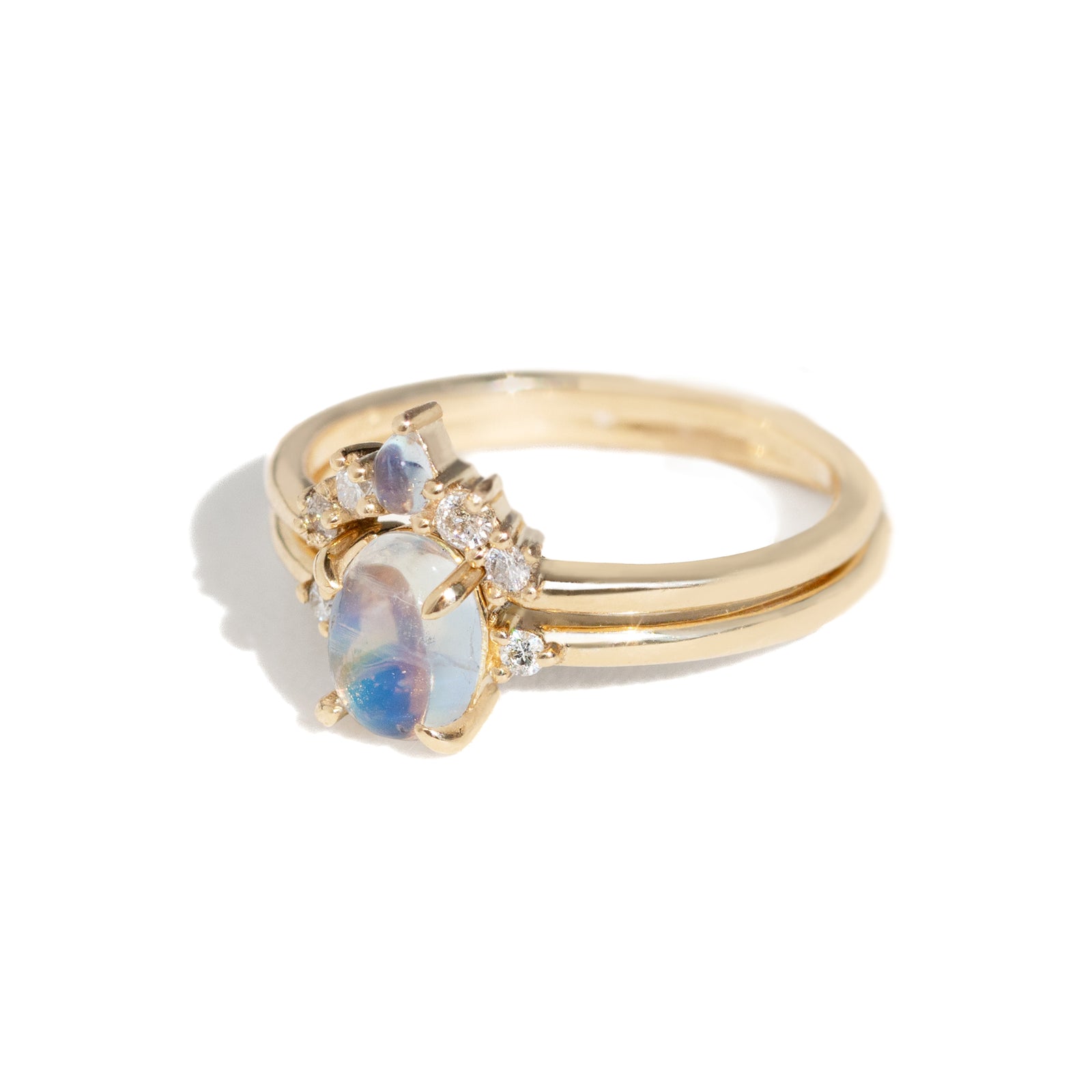 The classic Grace Ring's three stone design makes it perfect for your special day. This unique ring features an oval rainbow moonstone adorned with small diamonds, making it a truly one-of-a-kind piece. Pair this ring with Blossom Moonstone Contour Band to create your dream ring stack. 