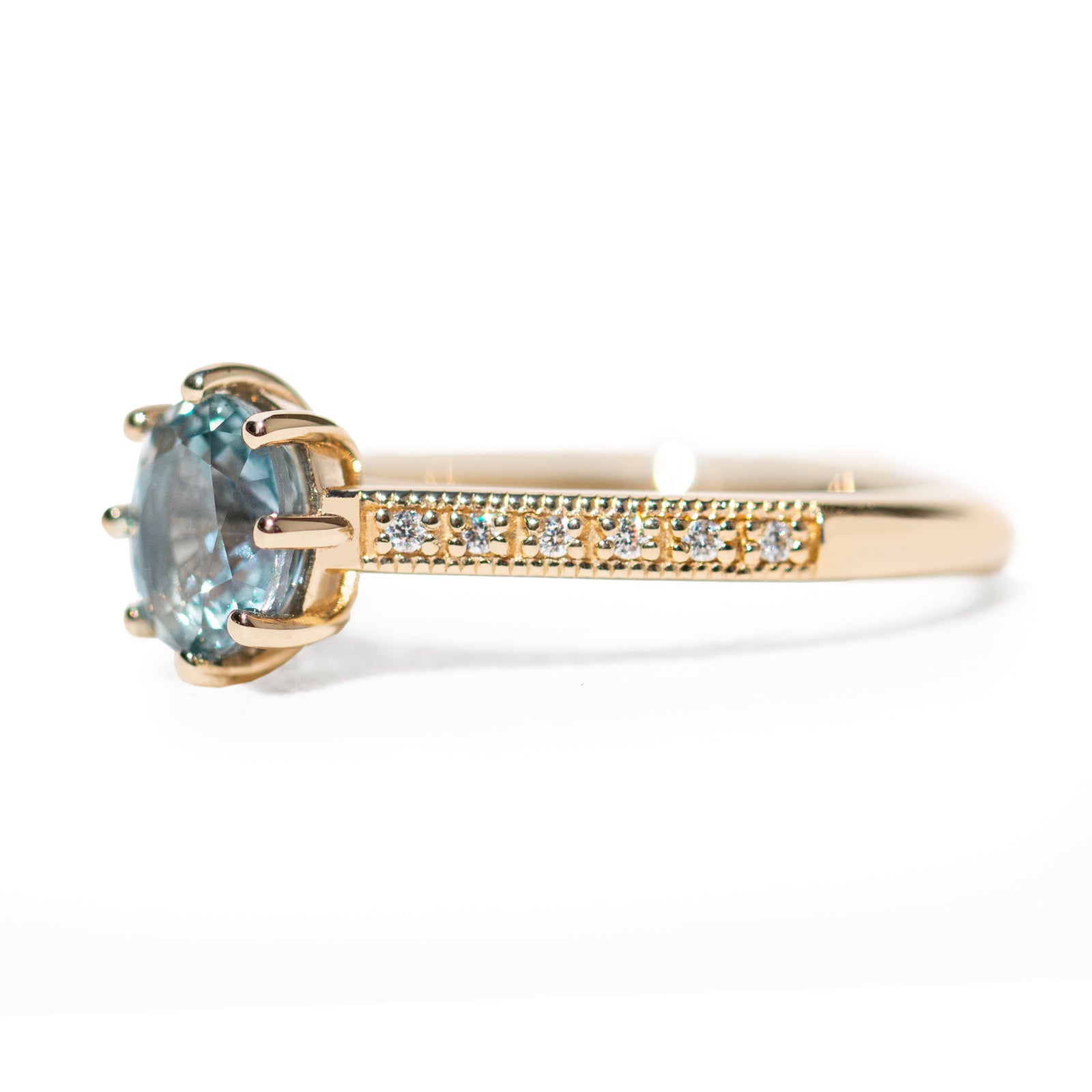 The 1.3ct. Oval Montana Sapphire Audrey Ring features a rich blue-green Montana sapphire on a band with delicate milgrain detailing. The elegant 8-prong design securely holds your stone, adding a unique touch. This ring is perfect for those who love timeless and intricate design. 