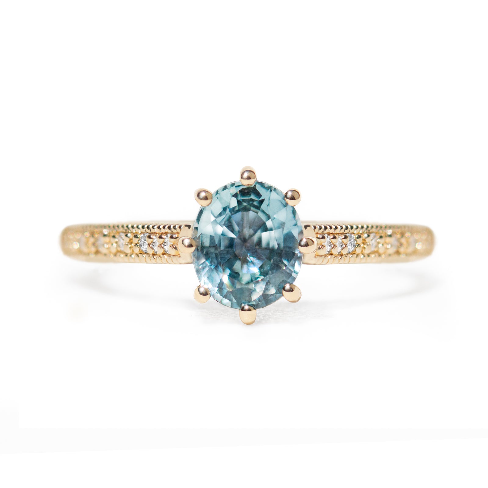 The 1.3ct. Oval Montana Sapphire Audrey Ring features a rich blue-green Montana sapphire on a band with delicate milgrain detailing. The elegant 8-prong design securely holds your stone, adding a unique touch. This ring is perfect for those who love timeless and intricate design. 