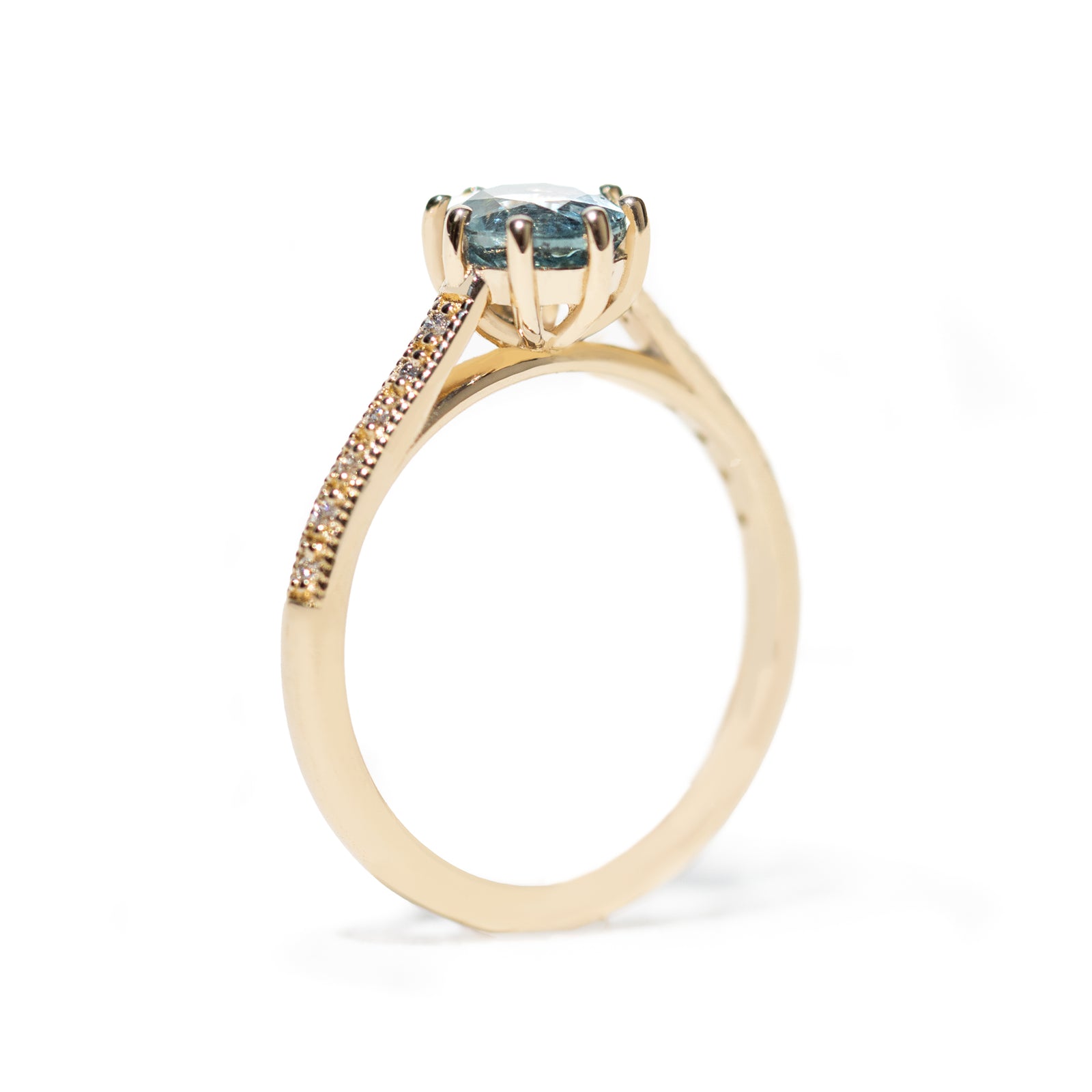 The 1.3ct. Oval Montana Sapphire Audrey Ring features a rich blue-green Montana sapphire on a band with delicate milgrain detailing. The elegant 8-prong design securely holds your stone, adding a unique touch. This ring is perfect for those who love timeless and intricate design. 