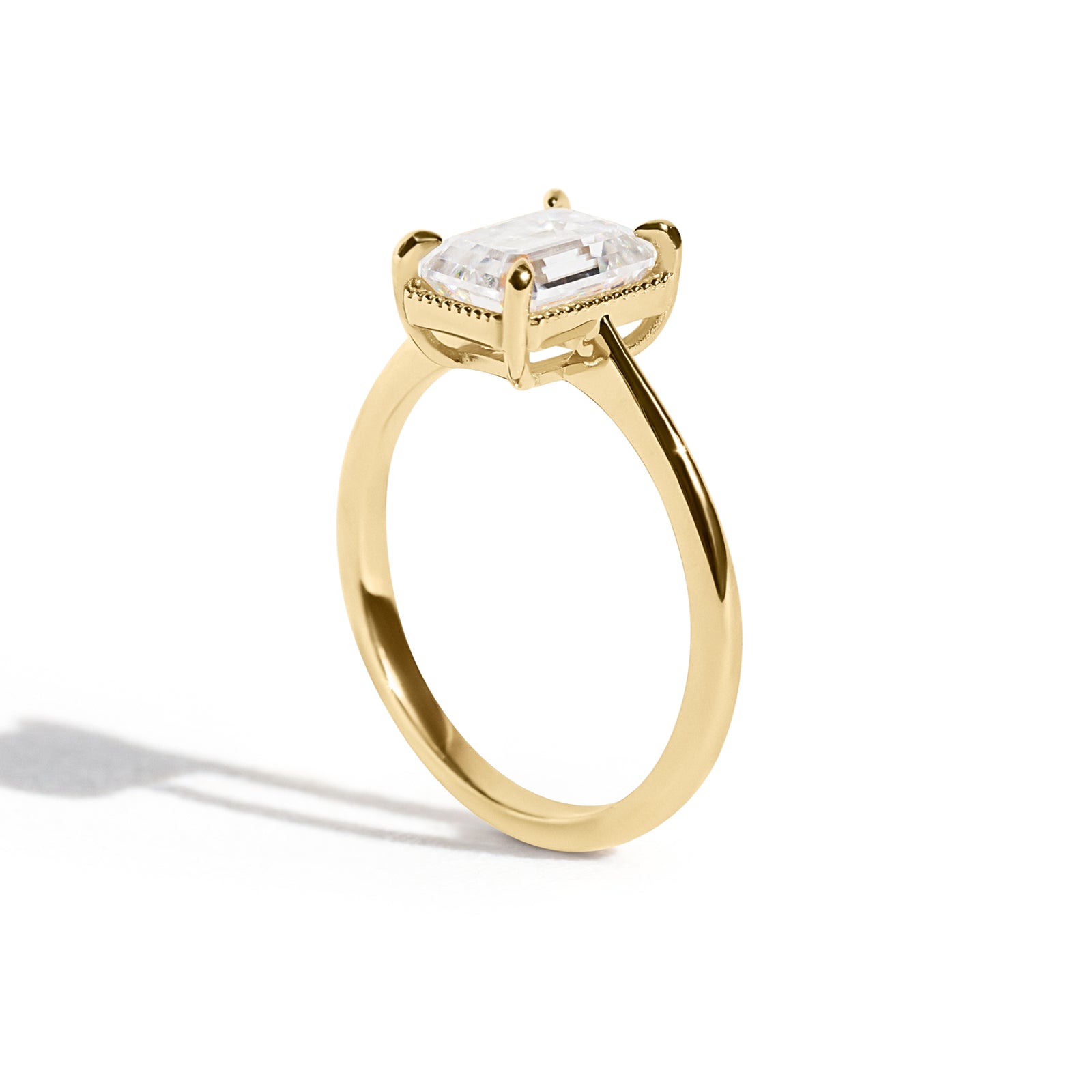 The Hera Ring features a 1.5ct emerald cut diamond or moissanite set in a delicately milgrained setting. This elegant and romantic design effortlessly blends old-world charm with a modern aesthetic. It’s the perfect choice for engagements, milestone celebrations, birthdays, and anniversaries, making it a timeless piece.