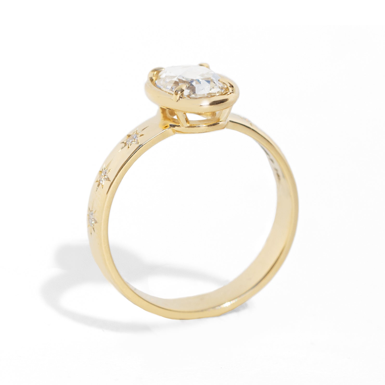 Gold ring with a diamond on a white background