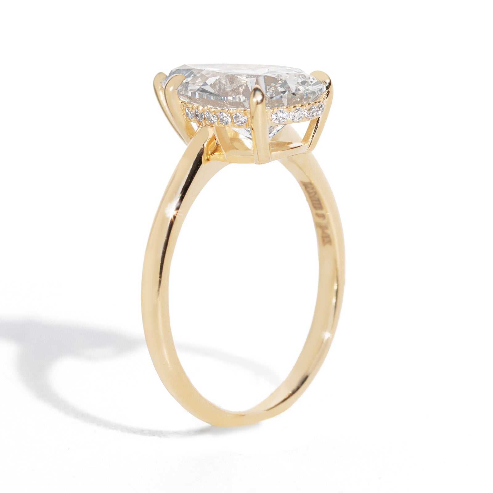 Gold ring with a diamond on a white background