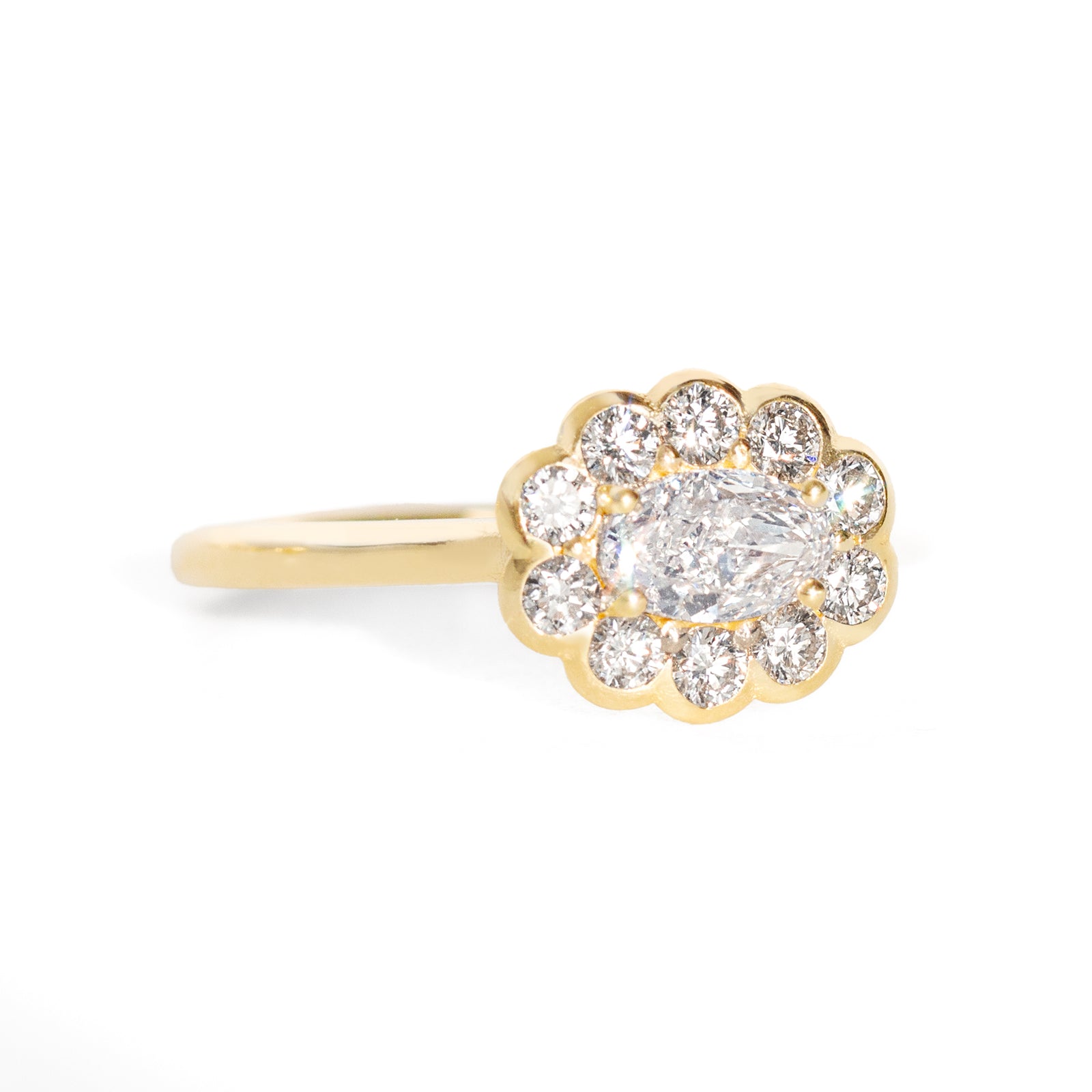 Gold ring with a diamond cluster on a white background