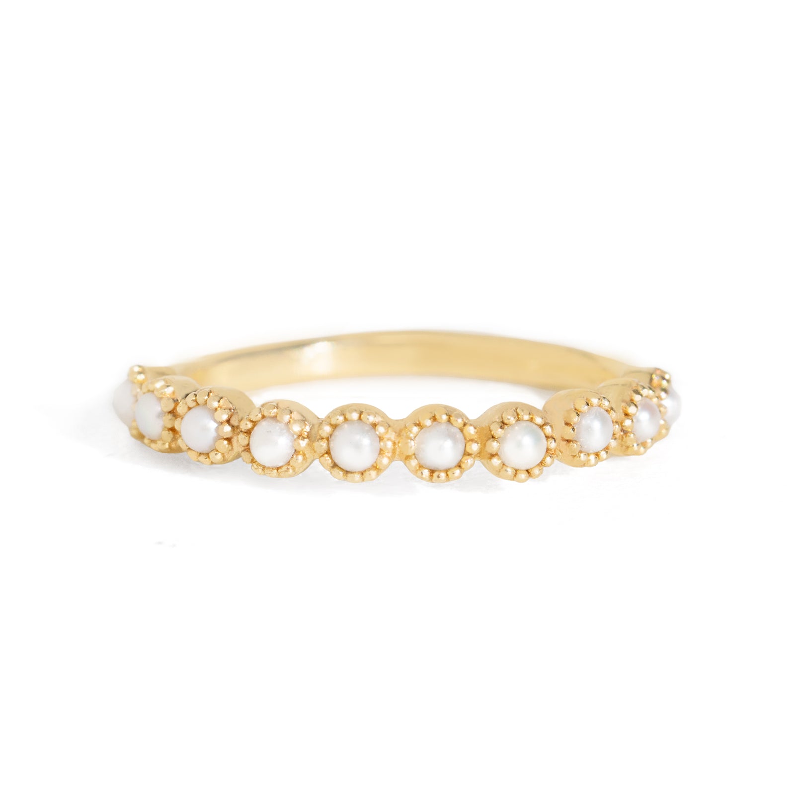 Gold ring with small pearls on a white background