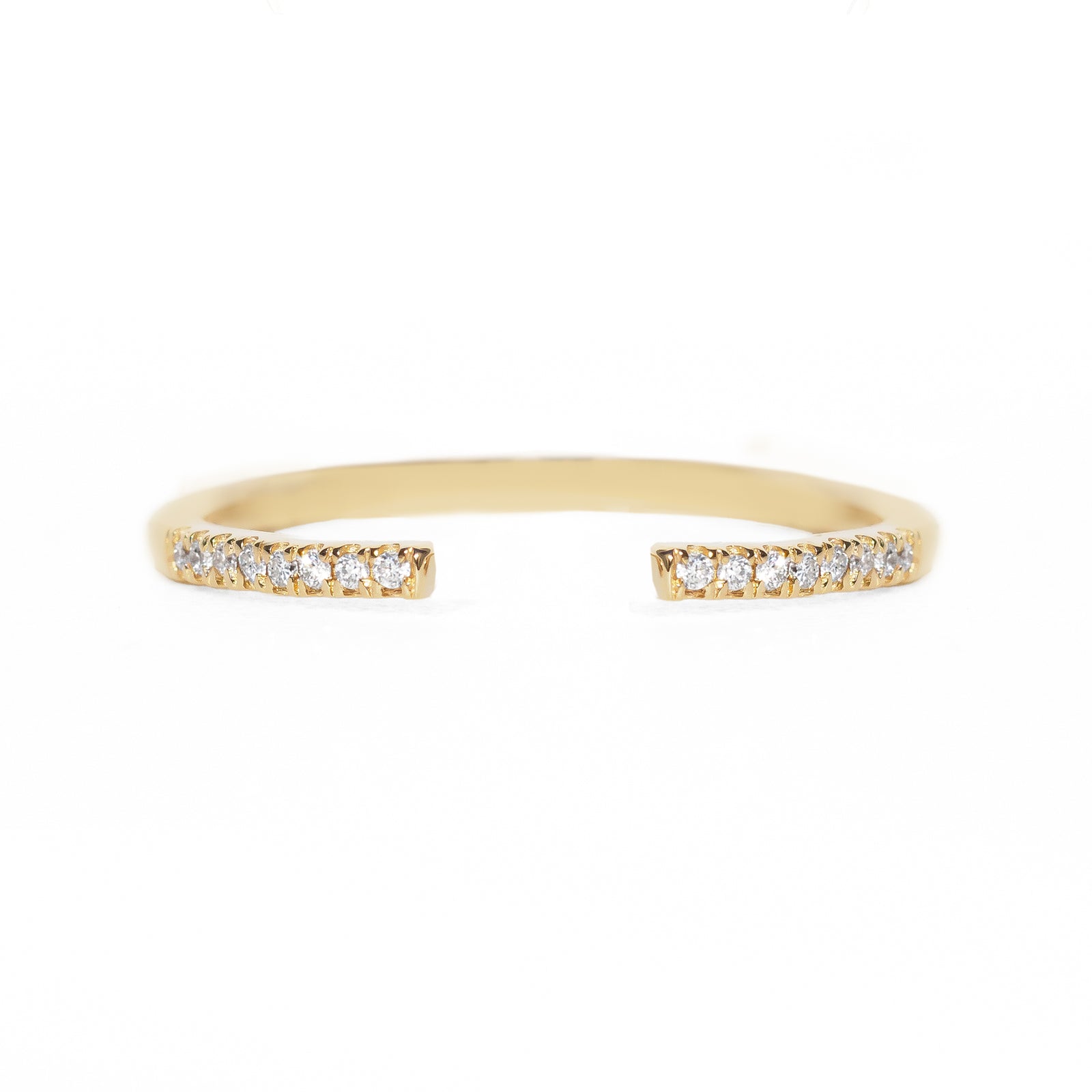 Open gold band with small diamonds on a white background