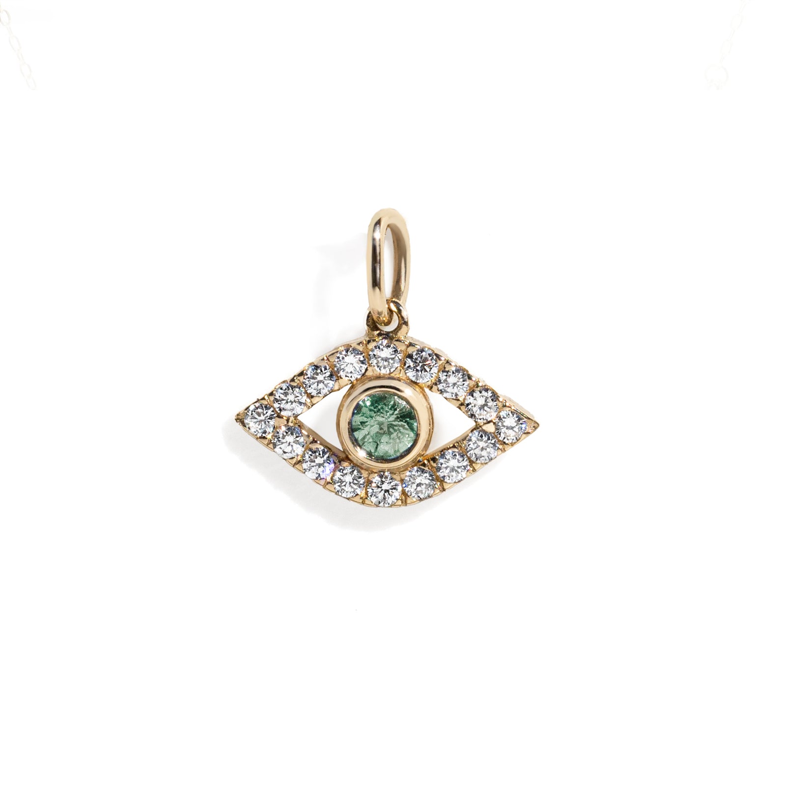 Gold eye charm with a green sapphire in the center surrounded by white diamond frame on a gold chain against white background.