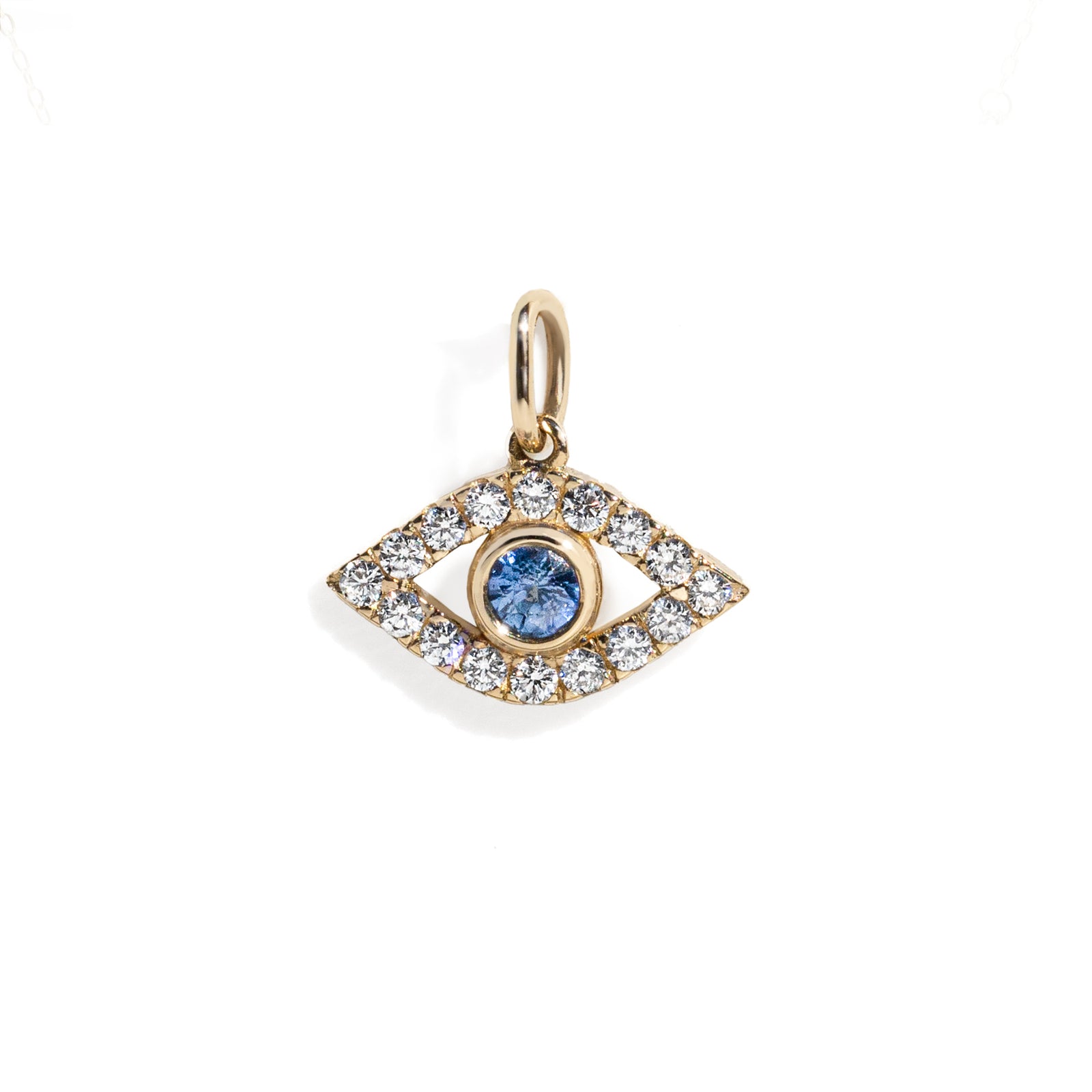 Gold evil eye pendant with blue gemstone and clear stones on a white background