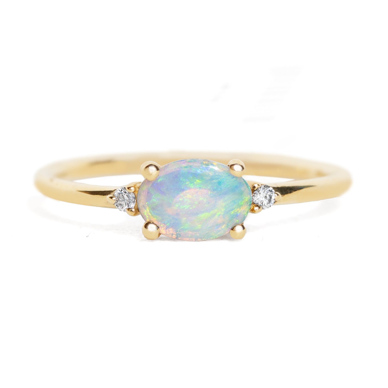 Gold ring with a central opal stone and smaller diamonds on a white background