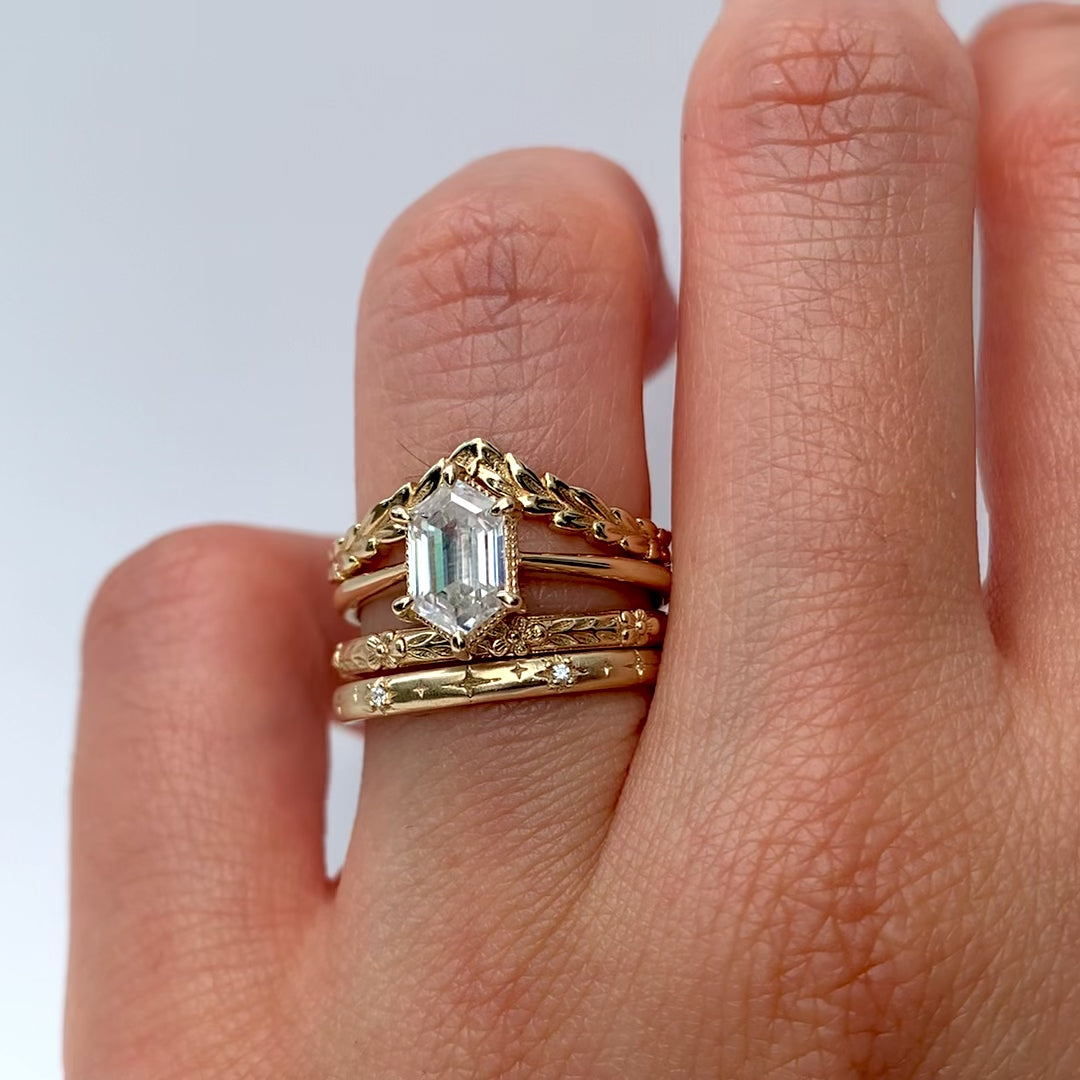 The Hera Ring showcases a 1.5ct hexagon lab diamond or moissanite, with a delicately highlighted hexagon step cut and milgrain accents on the setting. This elegant and romantic ring effortlessly combines antique charm with a modern aesthetic. It serves as the perfect choice for engagements, milestone celebrations, birthdays, and anniversaries, making it a versatile and timeless piece.