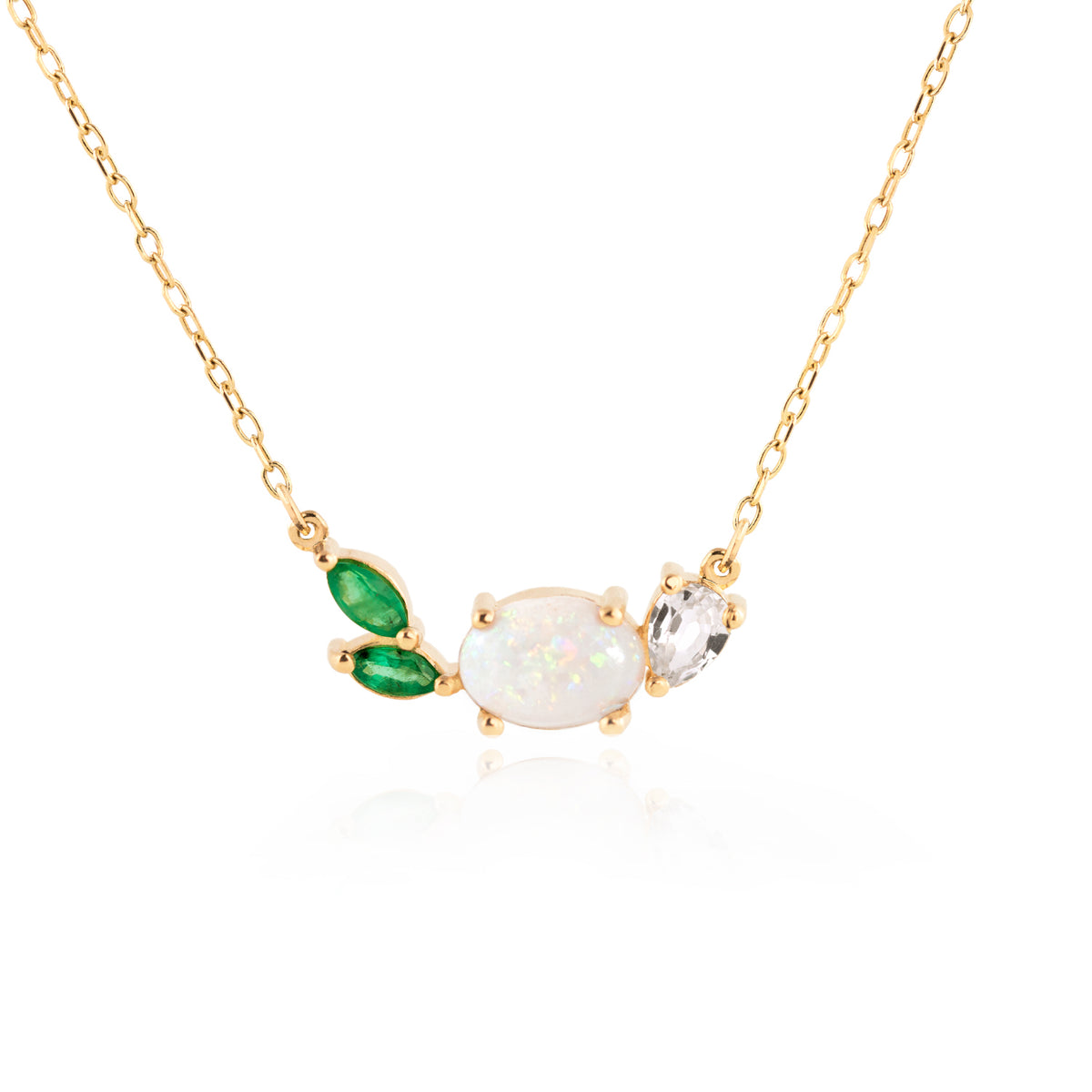 Opal Emerald Necklace by Jamie Park Jewelry This beautiful, 14K gold-cast necklace is inspired by the tranquility of a lush evergreen. Adorned with a cluster of gorgeous gemstones, including an Australian opal and two emeralds, it&#39;s finished with a sparkly pear-cut lab diamond.