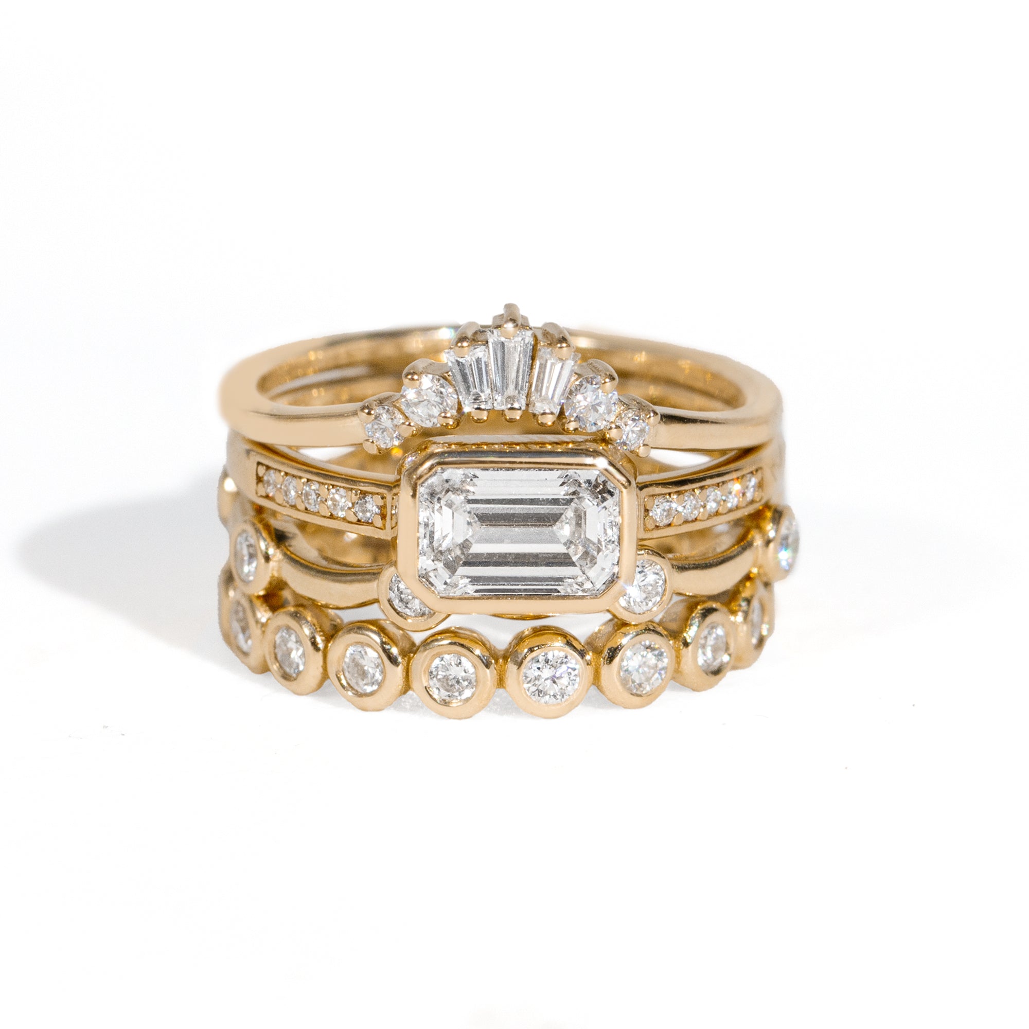 Gold ring with small diamonds on a white background