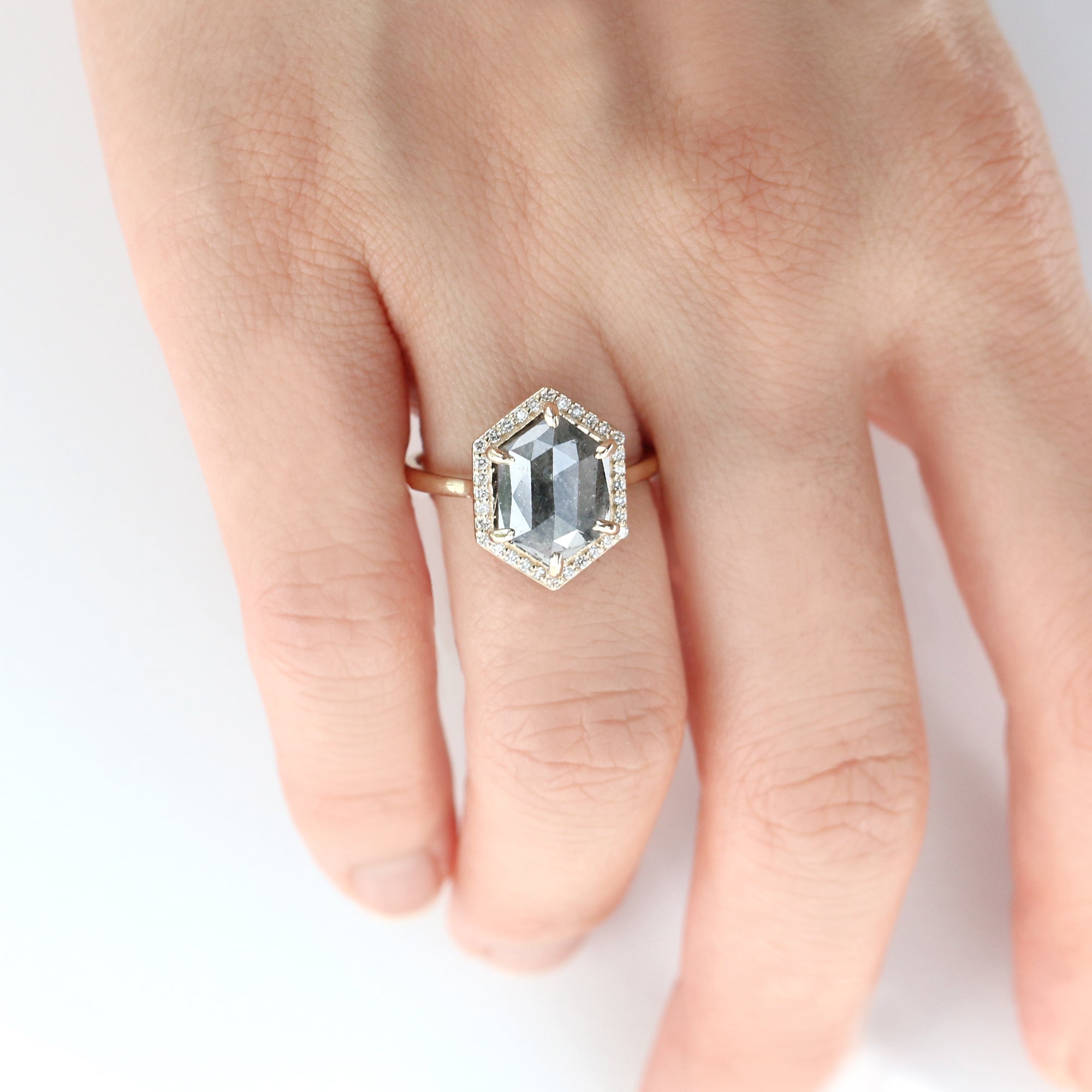 Jamie Park Jewelry - 2.8ct. Hexagon Salt and Pepper Diamond Ring https://jamieparkjewelry.com/products/3ct-hexagon-diamond-ring Experience luxury with our newly restocked Hexagon Halo Diamond Ring. Embellished with a striking 2.8 ct salt and pepper diamond in a unique hexagon cut, this ring is made to catch the spotlight. The bold center gemstone framed by the radiant white diamond halo, sparkles with every movement you make. The perfect choice…