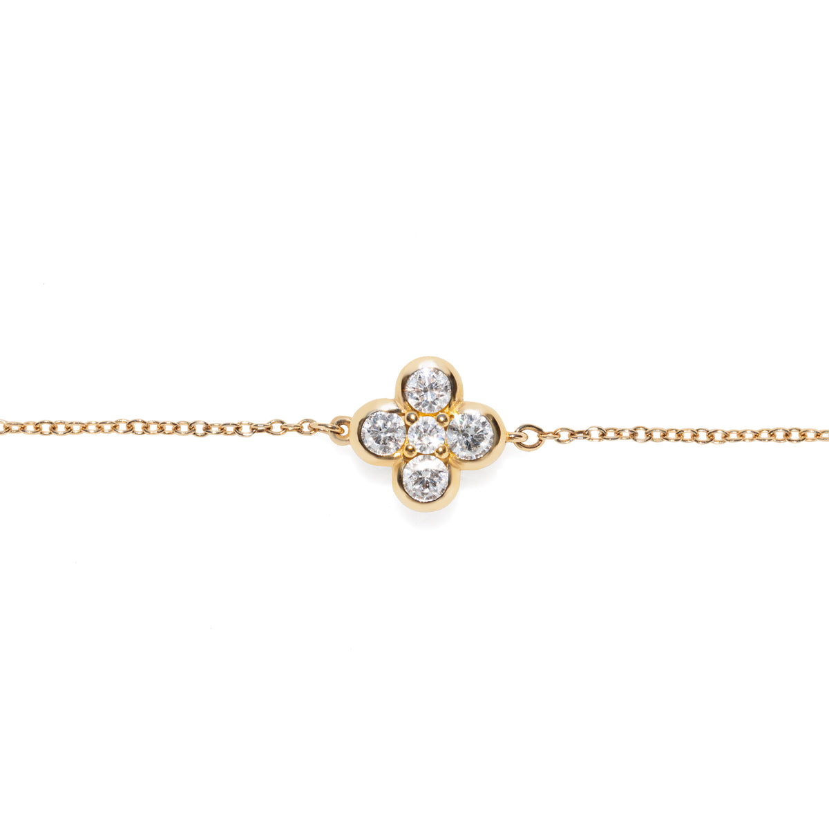 Gold bracelet with a clover-shaped diamond clasp on a white background
