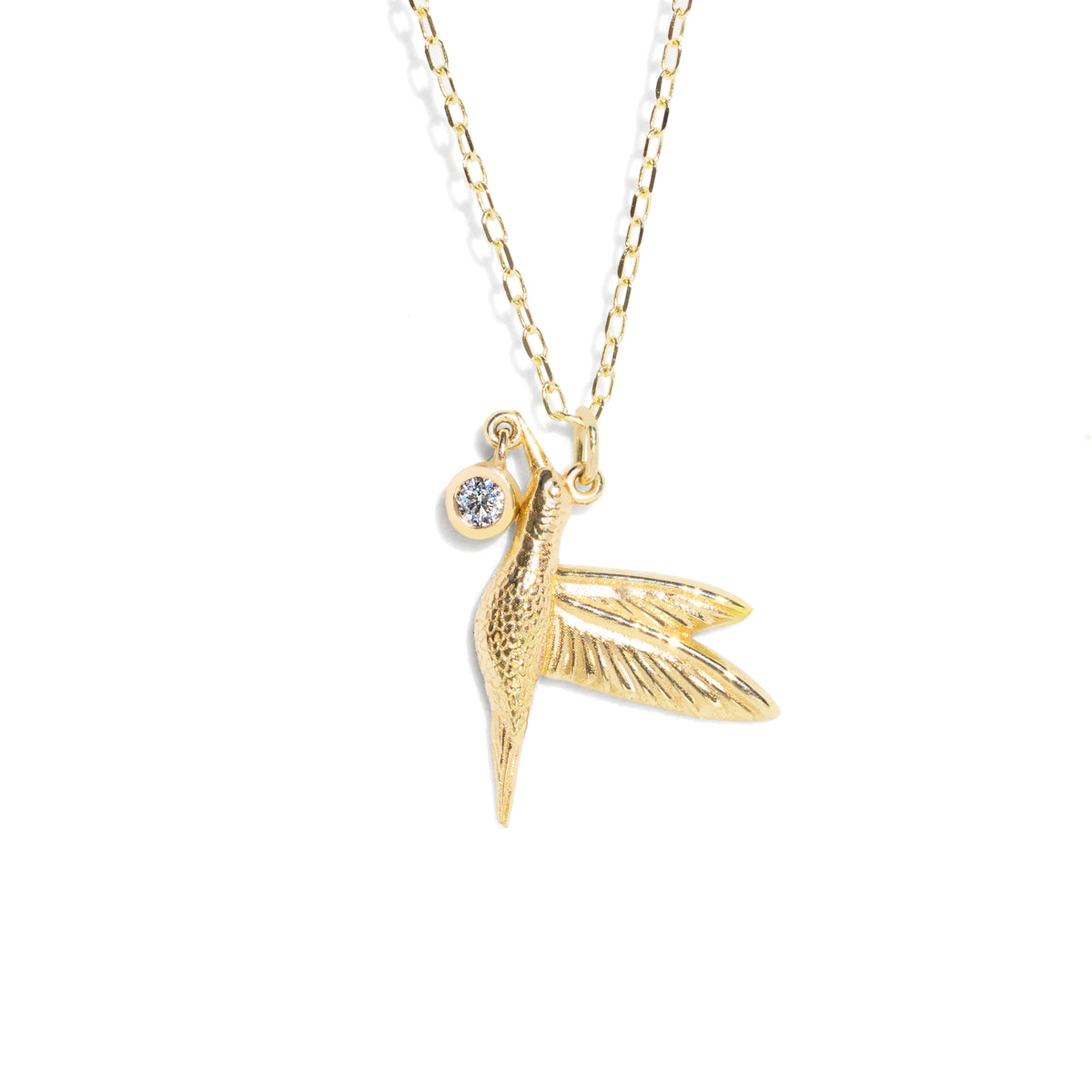 This stunning Diamond Hummingbird Necklace features a detailed hummingbird charm, accented with a sparkling diamond drop that catch the light with every movement. The elaborate details of this necklace make it a precious and exquisite piece of jewelry.