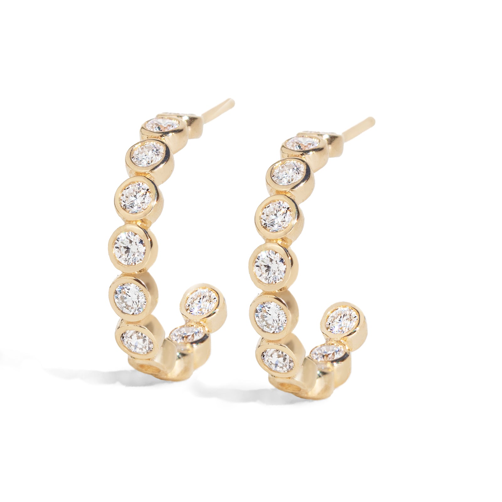 These luxurious Diamond Bezel Hoops features 0.66 total carat earth mined diamonds. The eternity diamond hoops are perfect for everyday wear or any special occasions. They will radiate with every movement. Featuring natural diamonds set in 14k bezel links, designed in an earring post style. 15mm in diameter, 3mm wide.&nbsp;