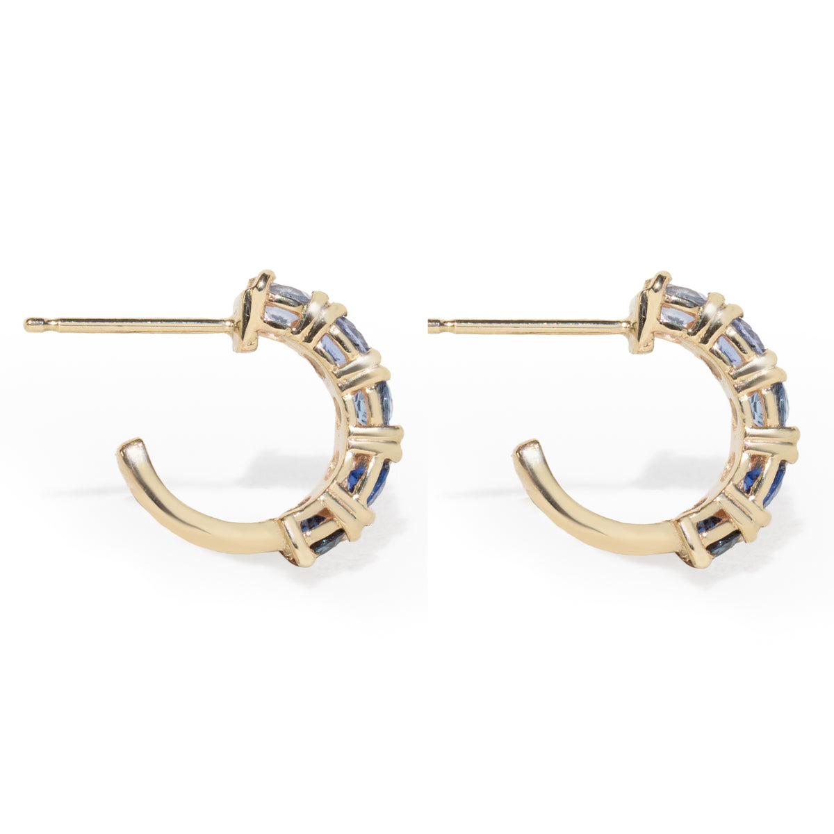 Gold hoop earrings with gemstones on a white background