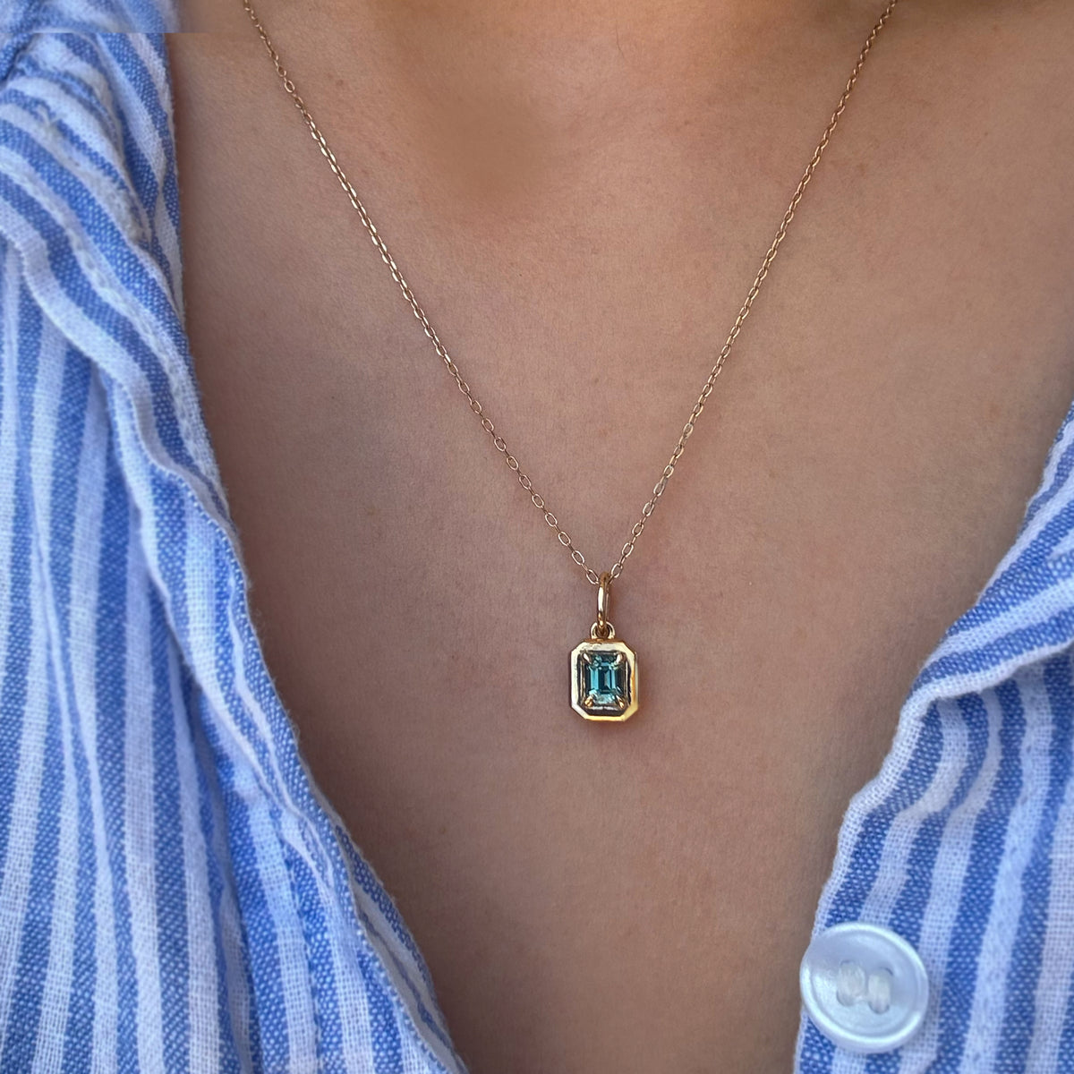 A gemstone necklace worn by a woman.