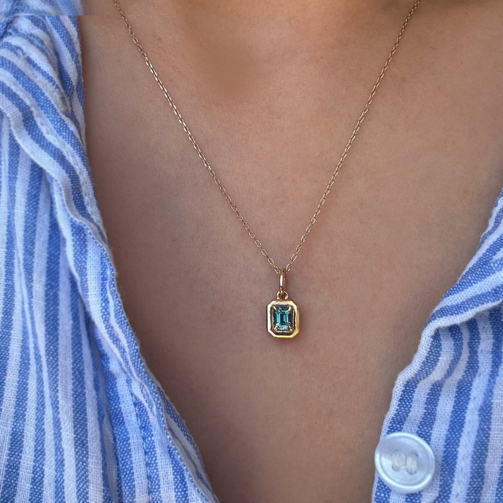 A gemstone necklace worn by a woman.
