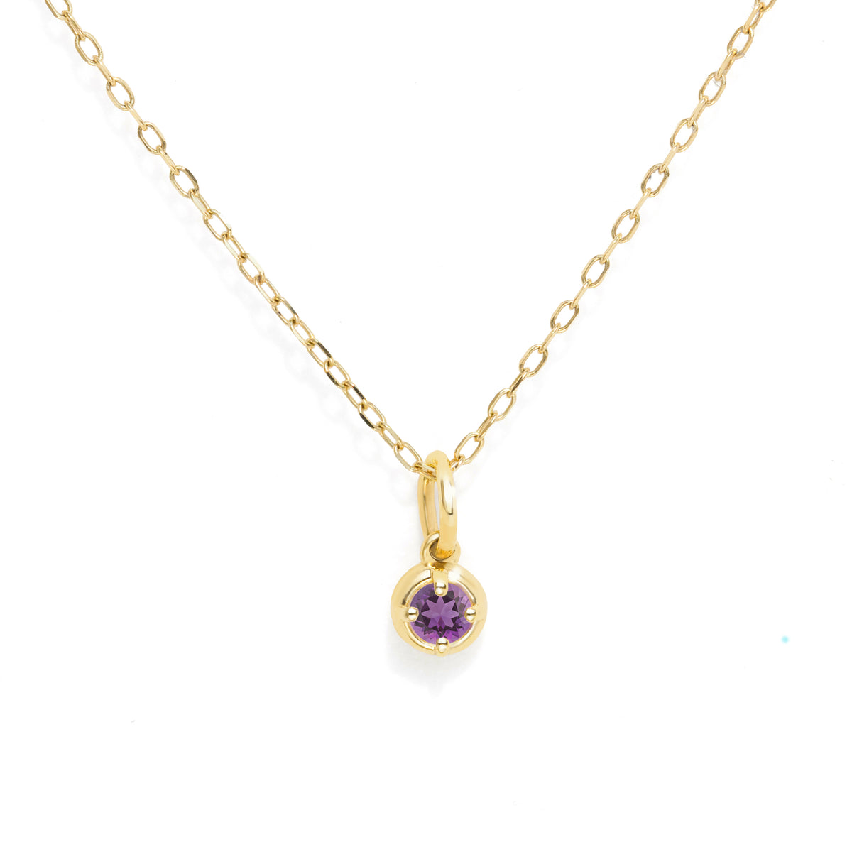 A delicate yellow gold chain necklace with a small bezel-set round purple gemstone pendant, displayed on a clean white background.