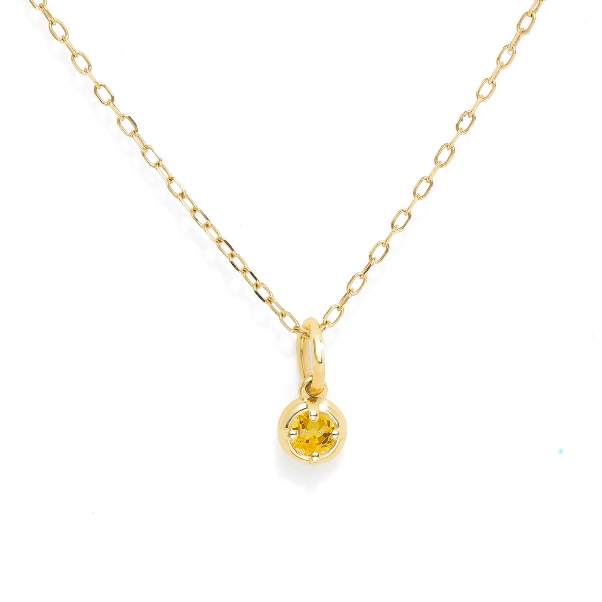 A delicate yellow gold chain necklace with a small round yellow gold gemstone pendant, displayed on a clean white background.