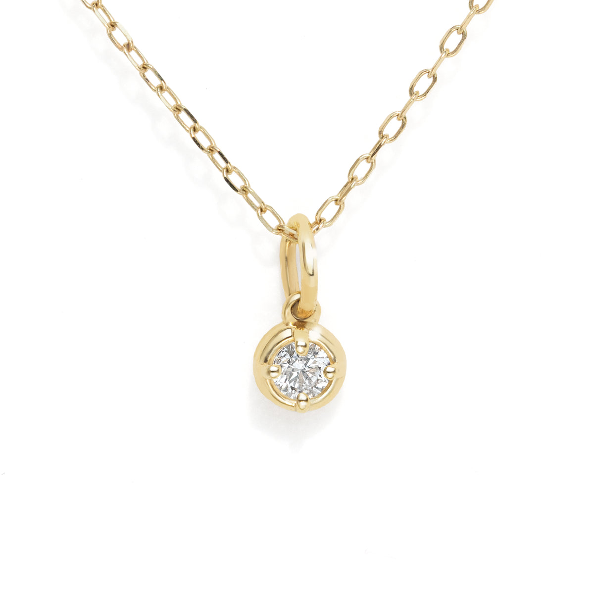 A delicate yellow gold chain necklace with a small round bezel-set diamond pendant, shown against a plain white background.