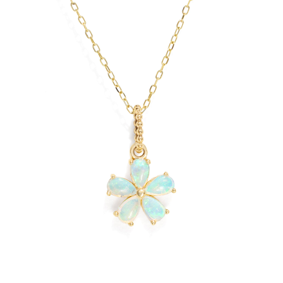 A flower shaped charm with opal gemstones on a gold chain