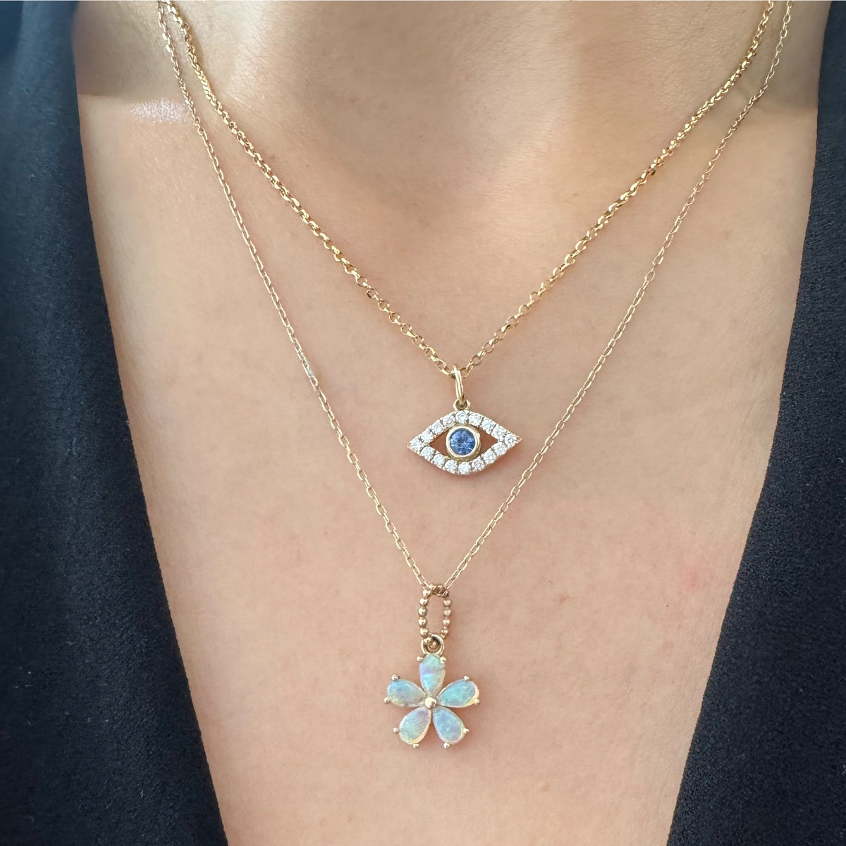 two gold color gemstone necklaces on a neck.