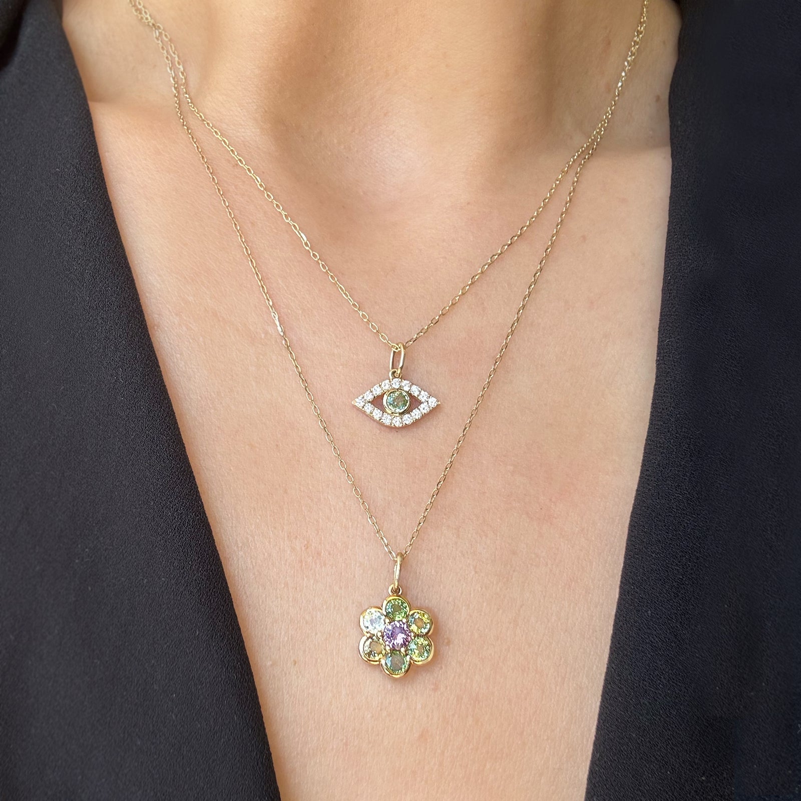 Two gemstone necklaces on a woman