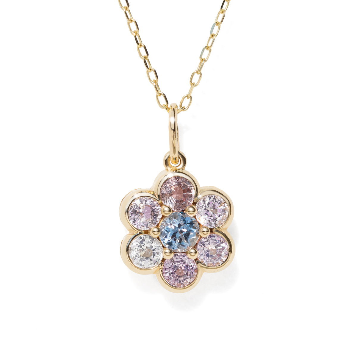 A gold flower-shaped pendant necklace featuring a central light blue round gemstone surrounded by six bezel-set round gemstones in pink, purple, and clear, suspended from a delicate gold chain on a white background.