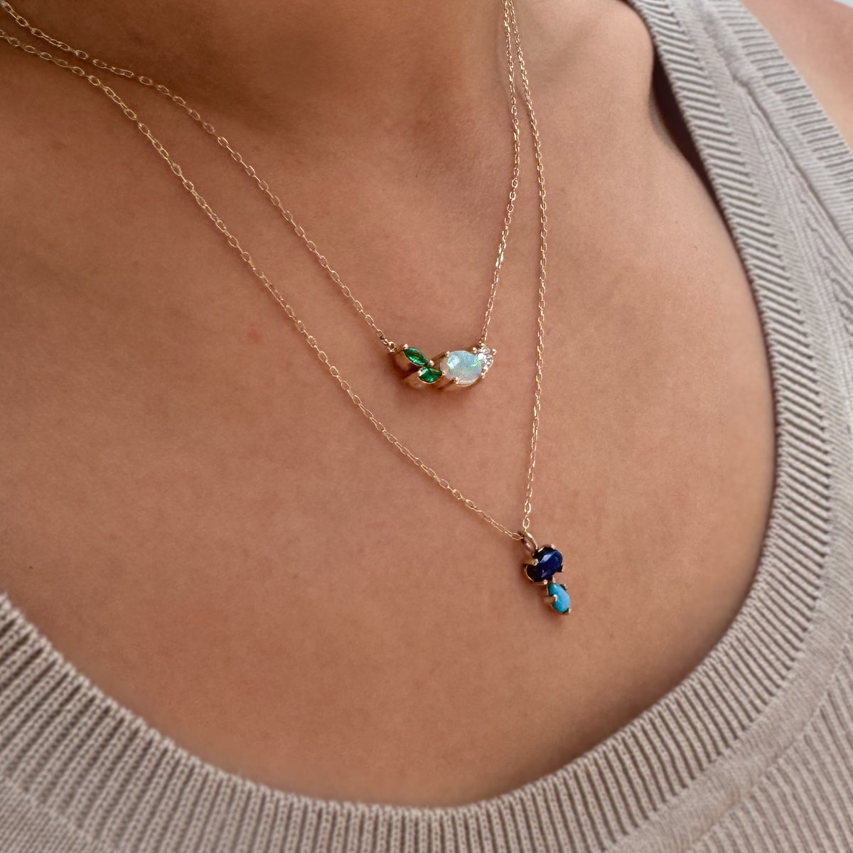 opal Necklace with small pendants on a person wearing a beige sweater