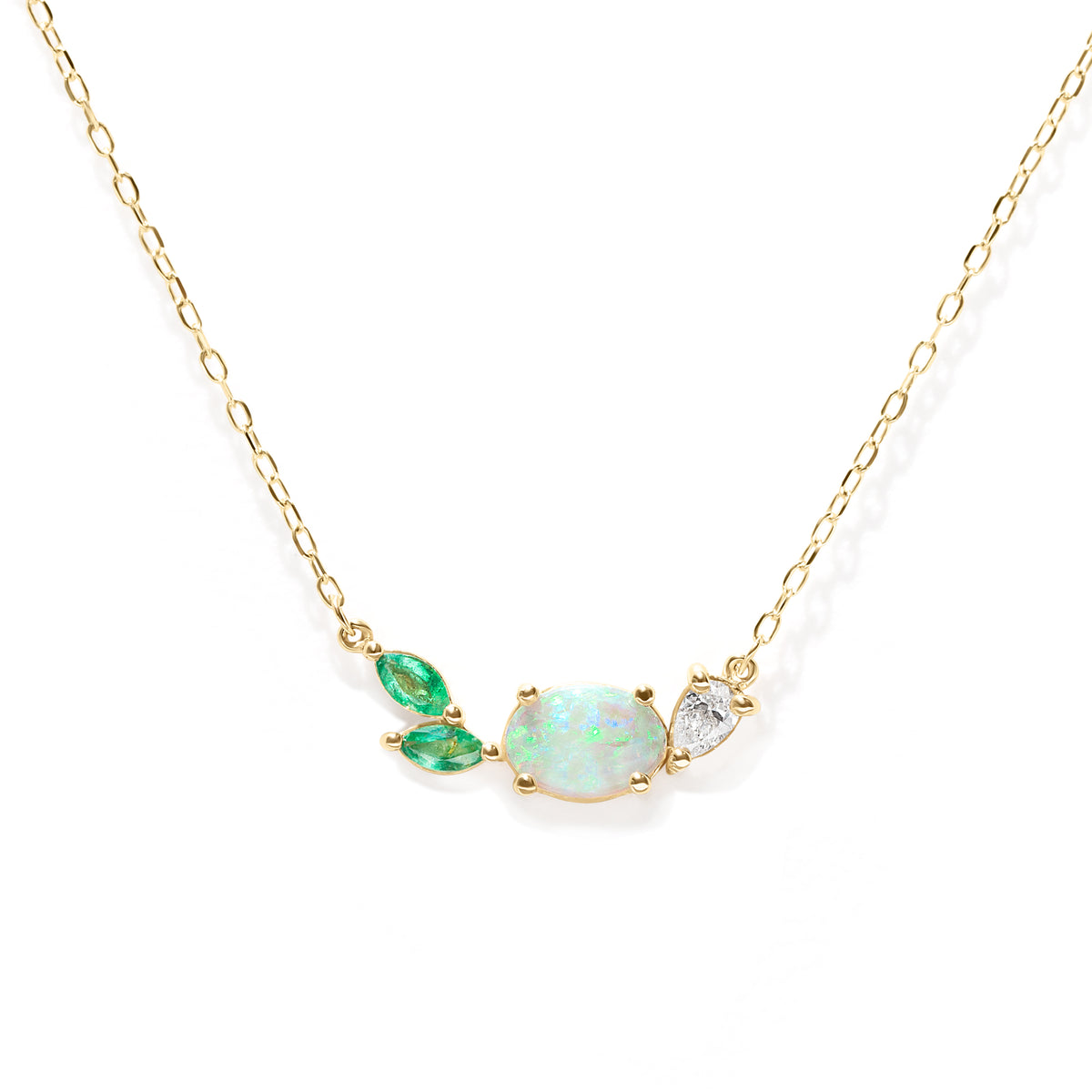 Necklace with green and opal gemstones on a gold chain against a white background