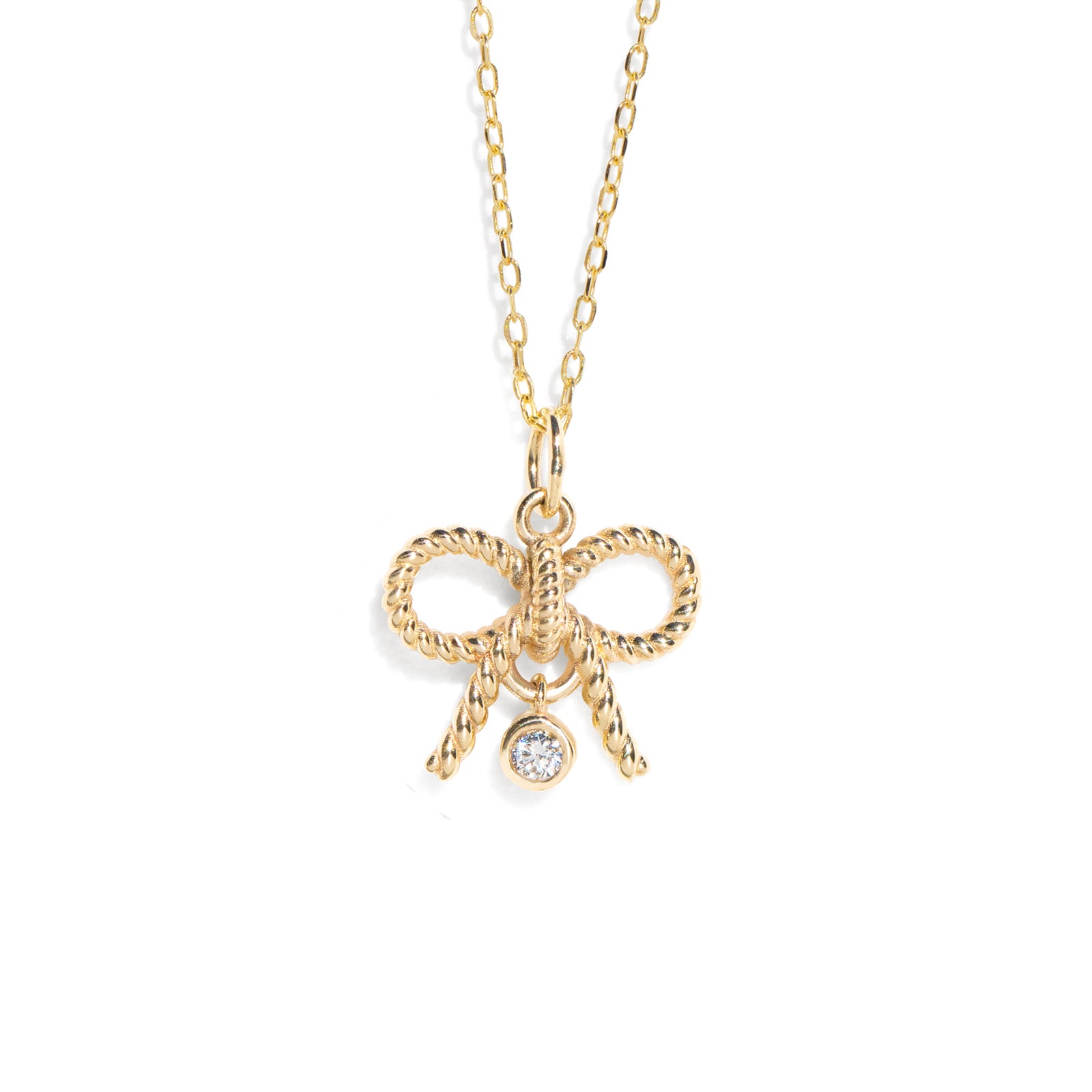 The Diamond Bow Necklace features a stunning natural diamond charm at its center, set on a delicately twisted bow charm, making it the perfect diamond piece for everyday wear. Crafted in solid 14K gold, it seamlessly blends modern elegance with a romantic, vintage-inspired allure.