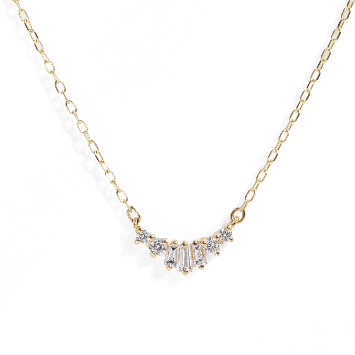 Gold necklace with diamond pendant on a white background