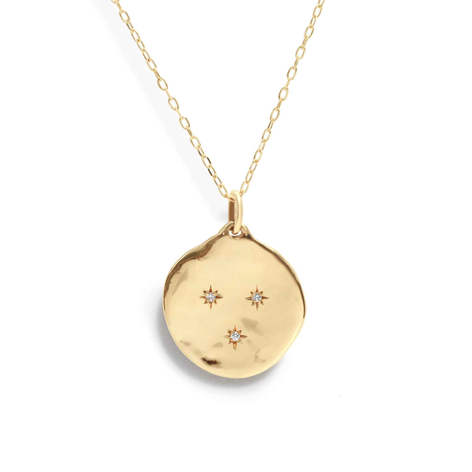 The Three Star Necklace features a hand-forged 14K gold round charm, adorned with three starburst-set natural diamonds at its center. 