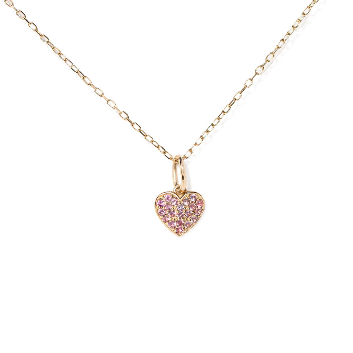Gold necklace with a pink heart-shaped pendant on a white background